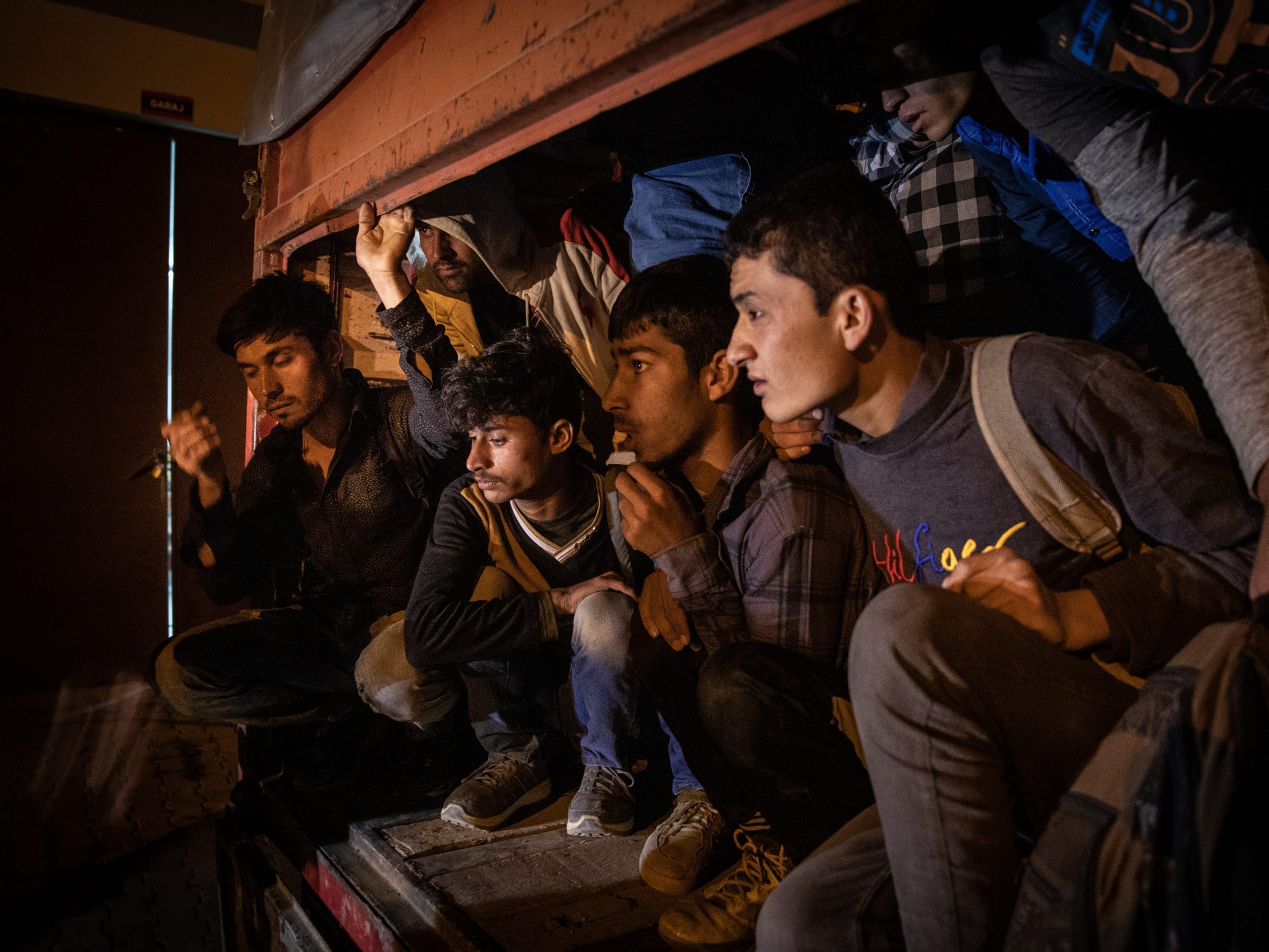 Afghan migrants waiting in a smuggler’s truck after it was seized in Turkey.