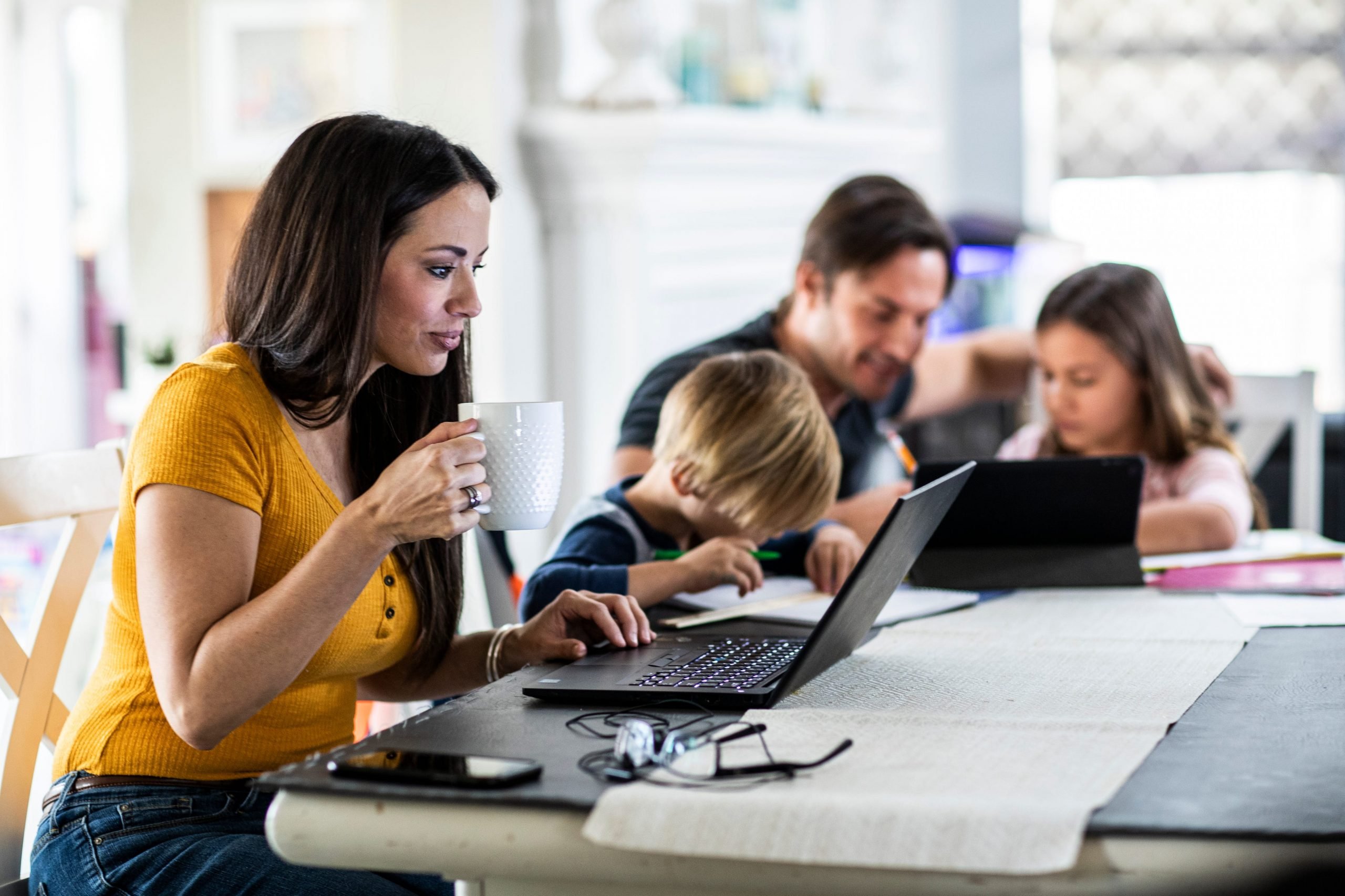 A mom working from home while her children do online school