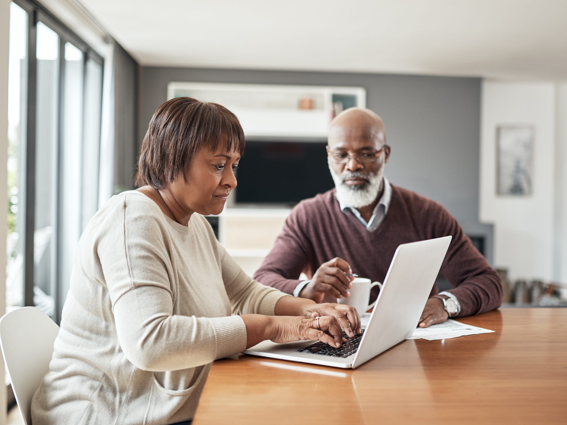 older couple doing paperwork at home