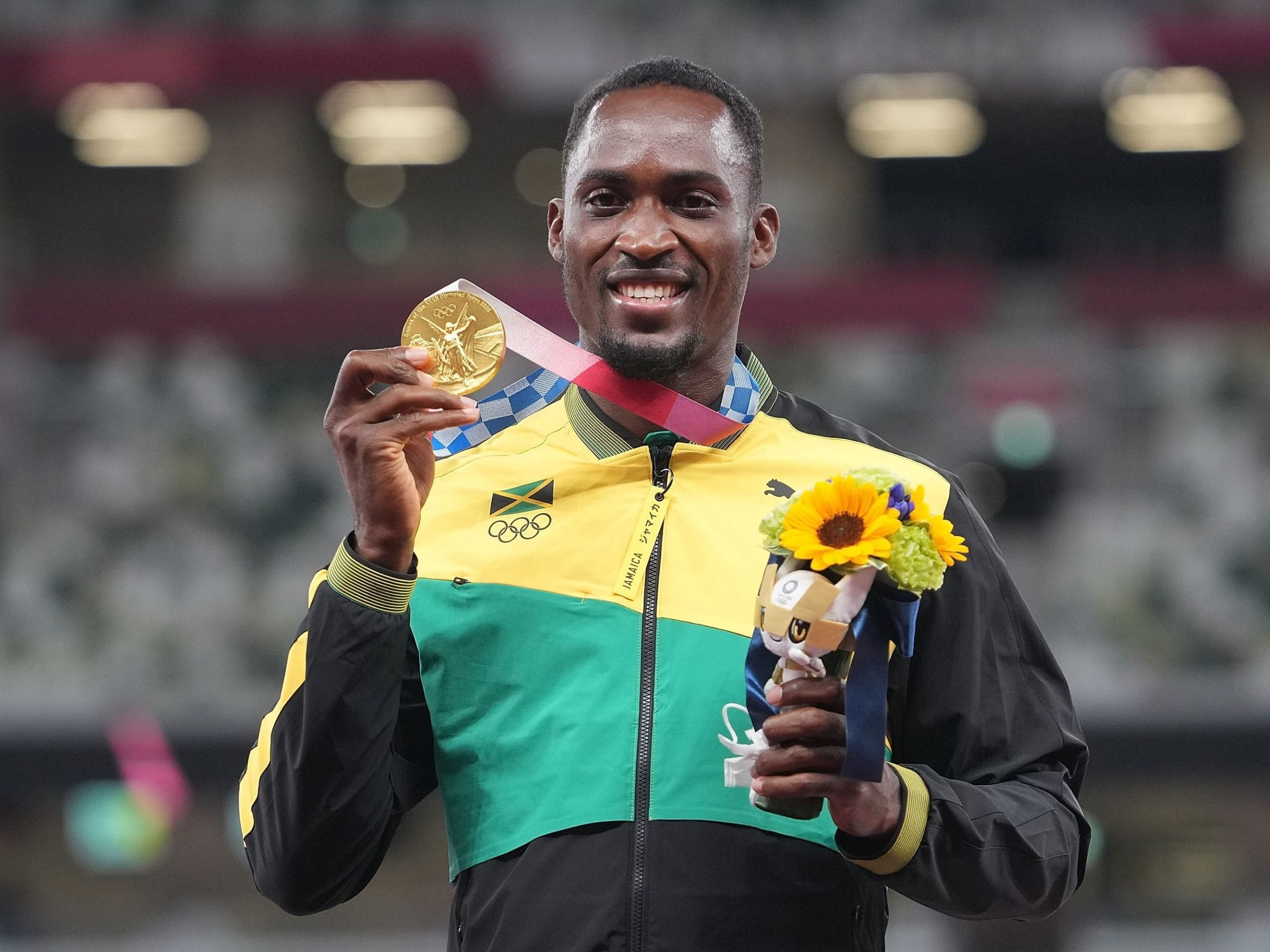 Gold medalist Hansle Parchment of Jamaica poses for a photo on the awarding ceremony