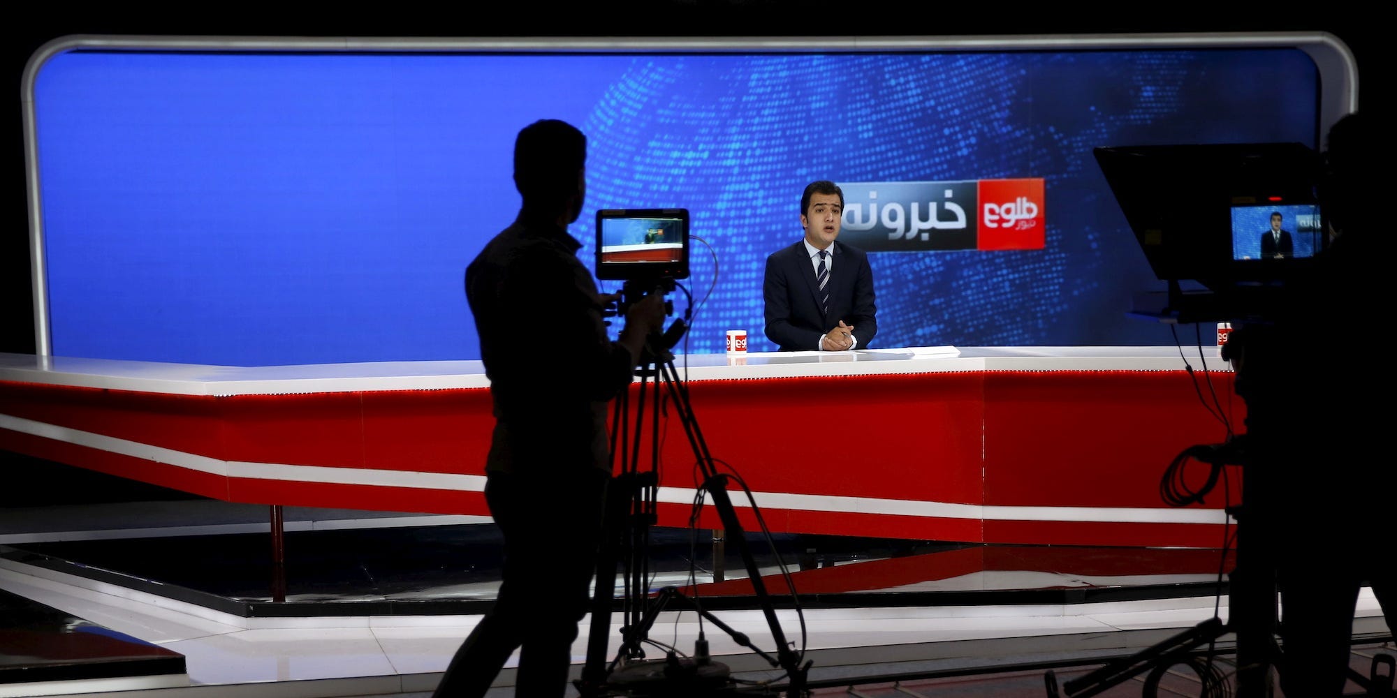 A cameraman films a news anchor at Tolo News studio, in Kabul, Afghanistan October 18, 2015.