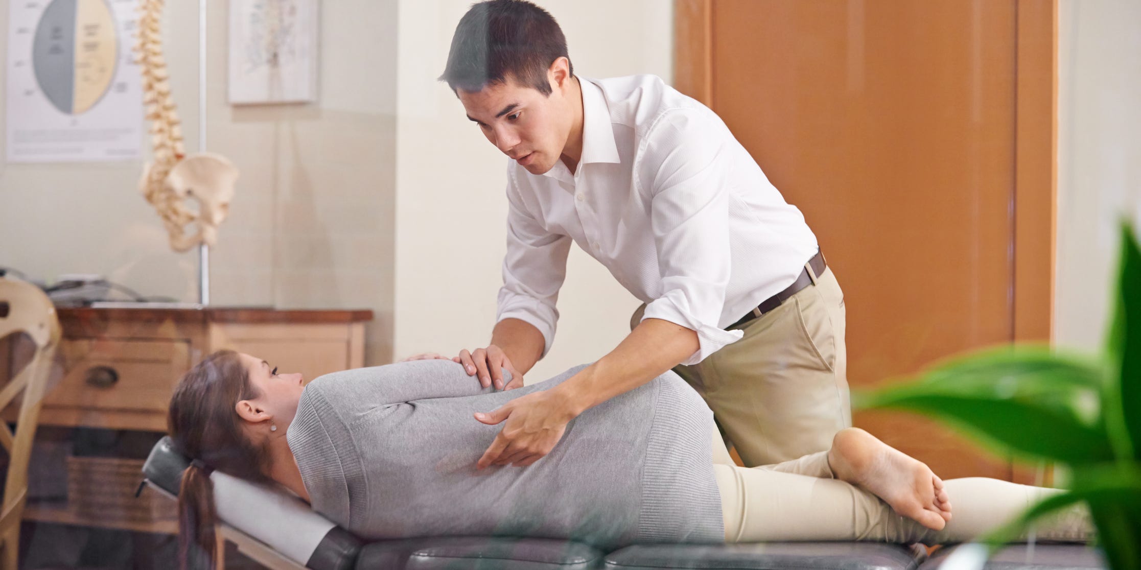 chiropractor adjusting a persons spine