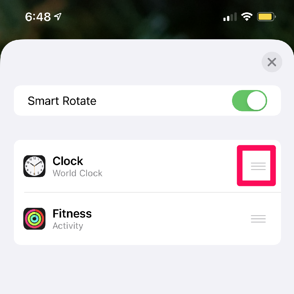 A screenshot of an iPhone edit smart stack menu with a box around the icon with three-horizontal bars for rearranging the app stack.