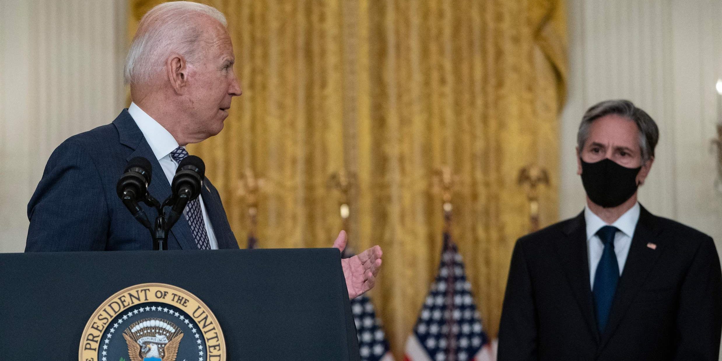 US President Joe Biden, with Secretary of State Antony Blinken (R), speaks about the ongoing US military evacuations of US citizens and vulnerable Afghans, in the East Room of the White House in Washington, DC, on August 20, 2021.