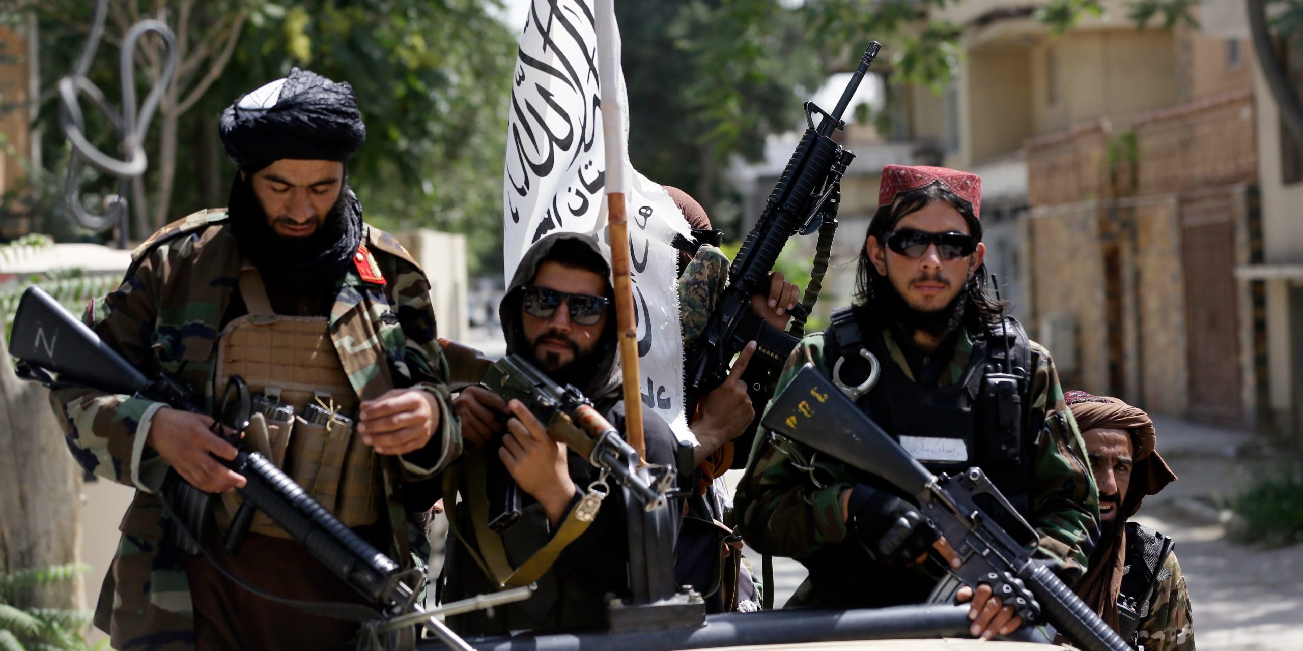 Taliban fighters display their flag on patrol in Kabul, Afghanistan.