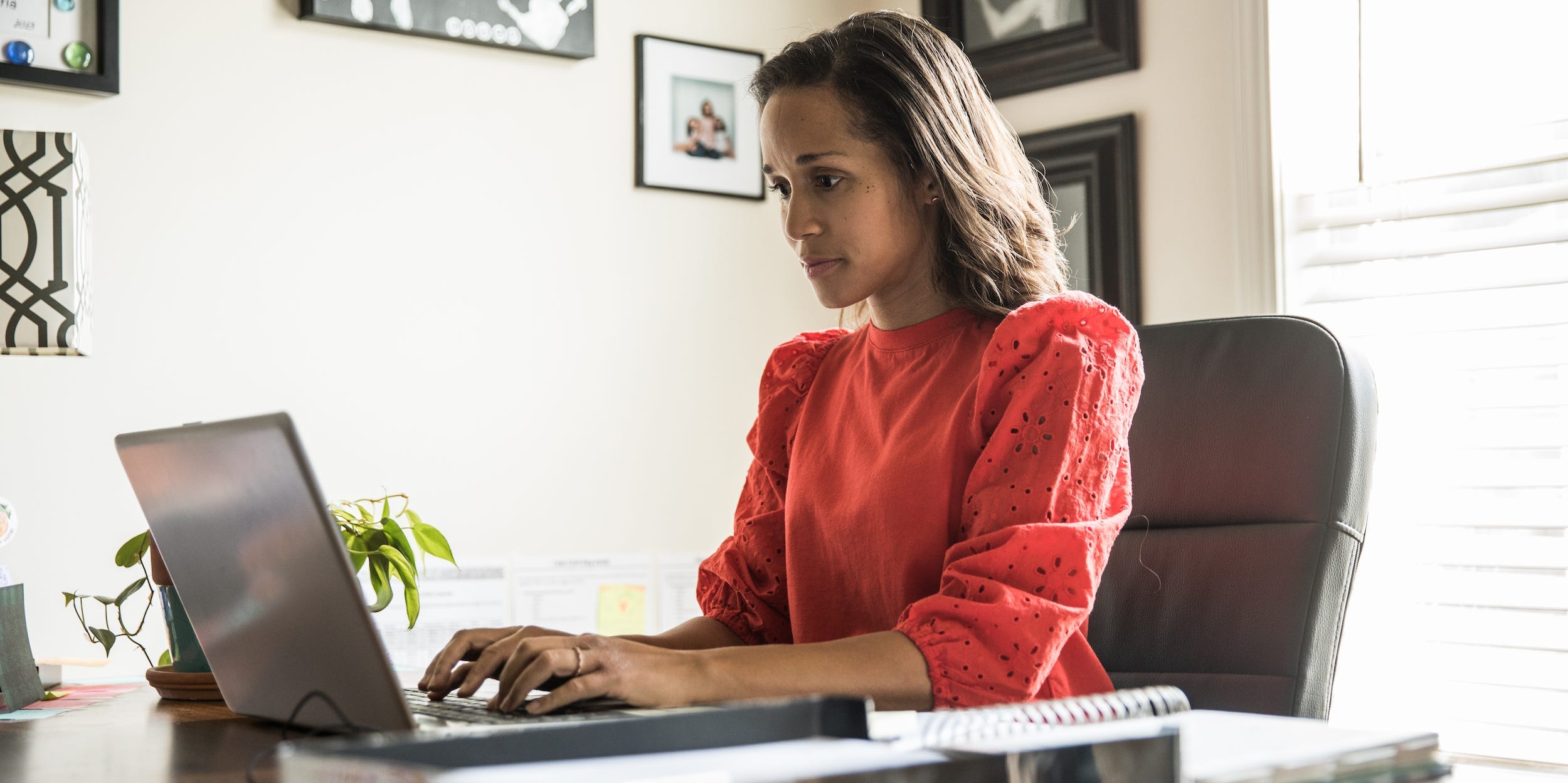 professional woman typing on laptop at desk