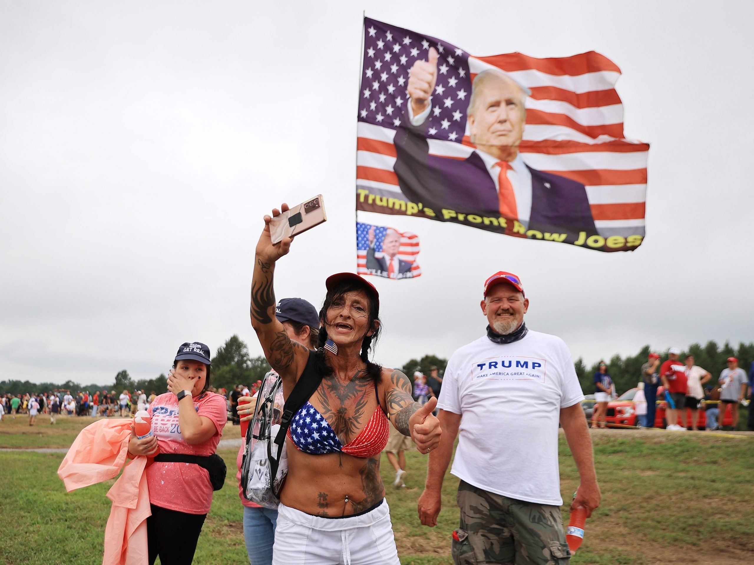 Thousands of supporters of former U.S. President Donald Trump wait in line to attend a "Save America" rally at York Family Farms on August 21, 2021 in Cullman, Alabama.