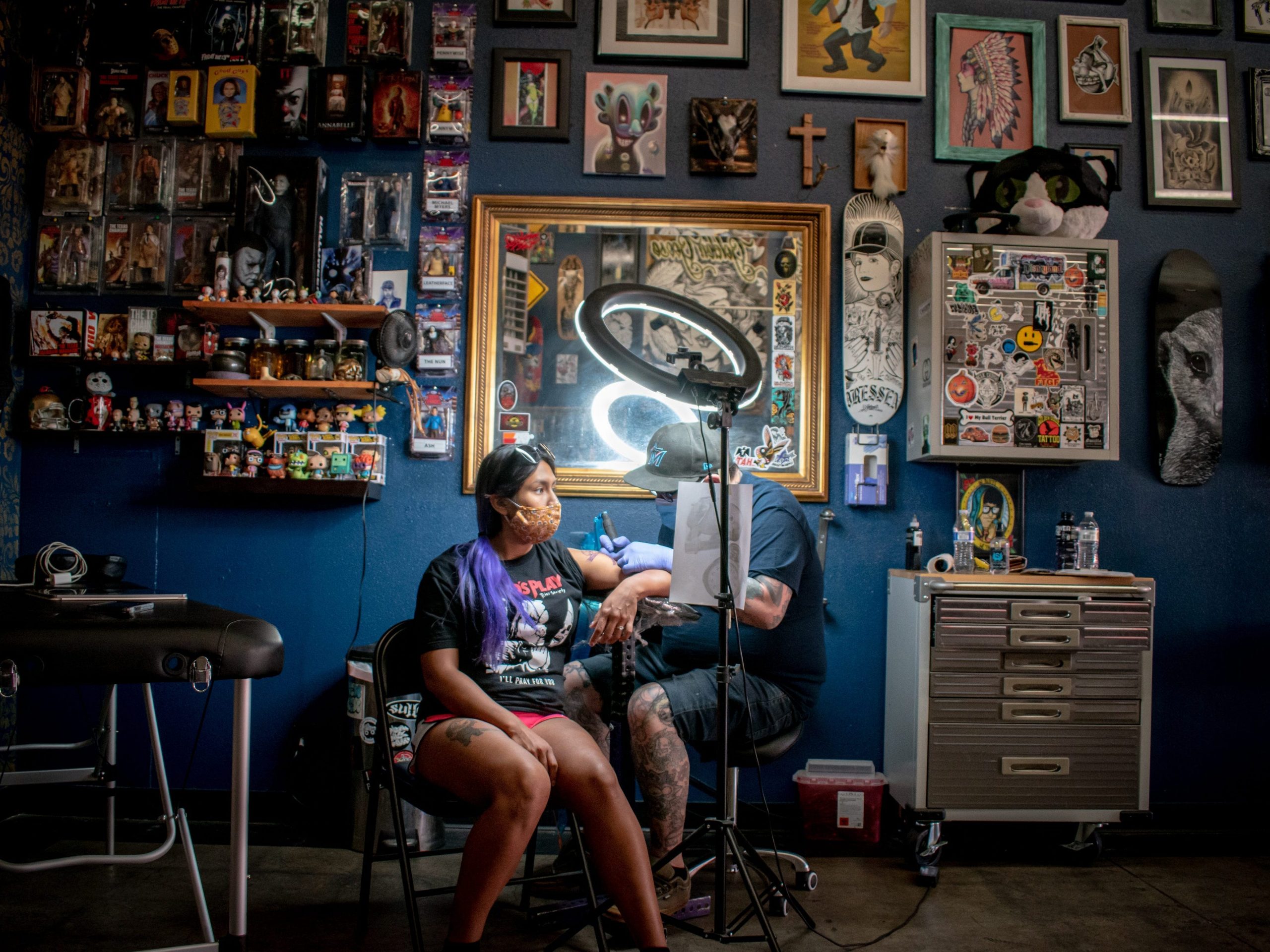 Woman gets a tattoo at a tattoo shop