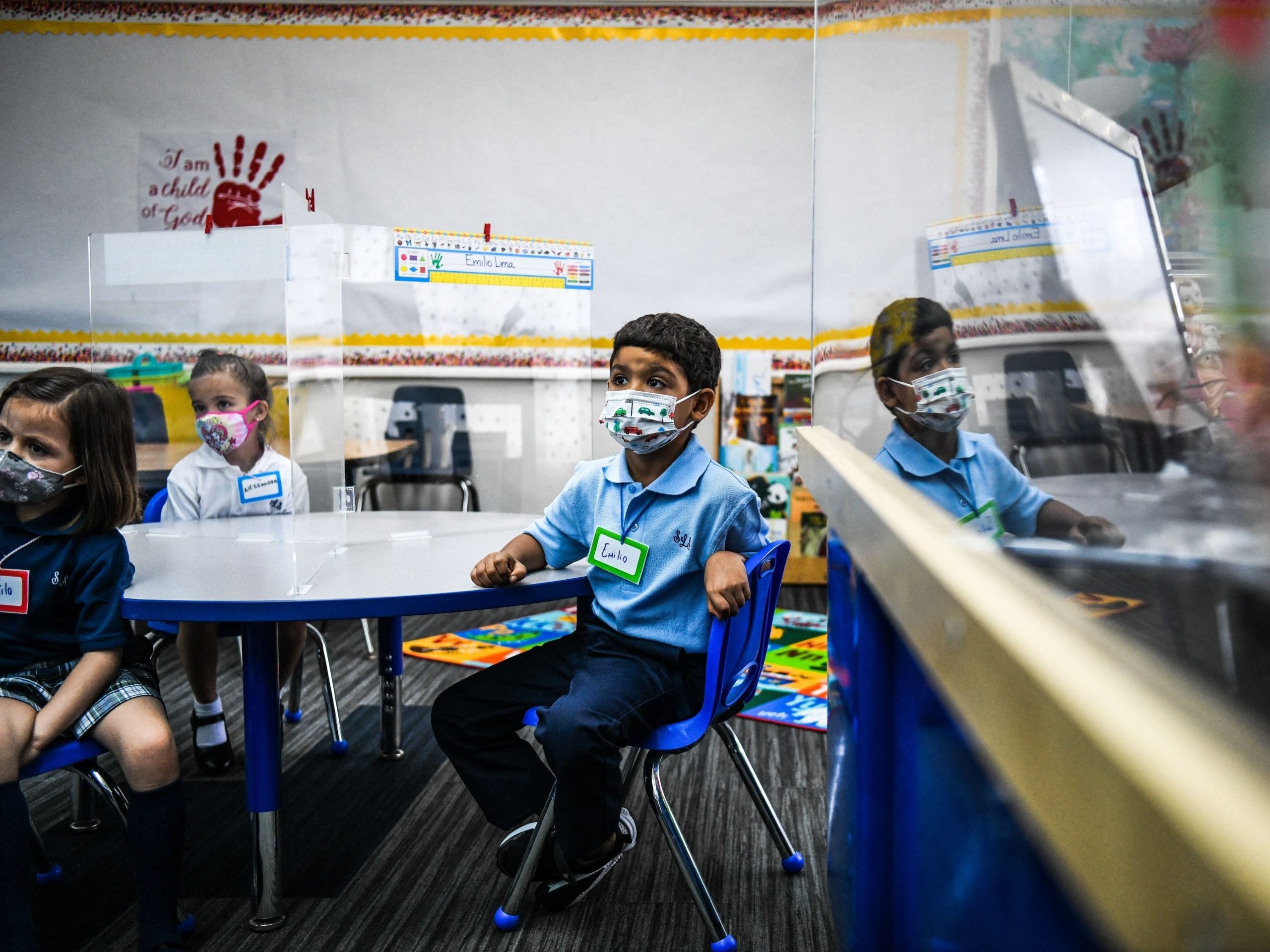 Student wear facemasks as they attend their first day in school after summer vacation at the St. Lawrence Catholic School in north of Miami, on August 18, 2021.