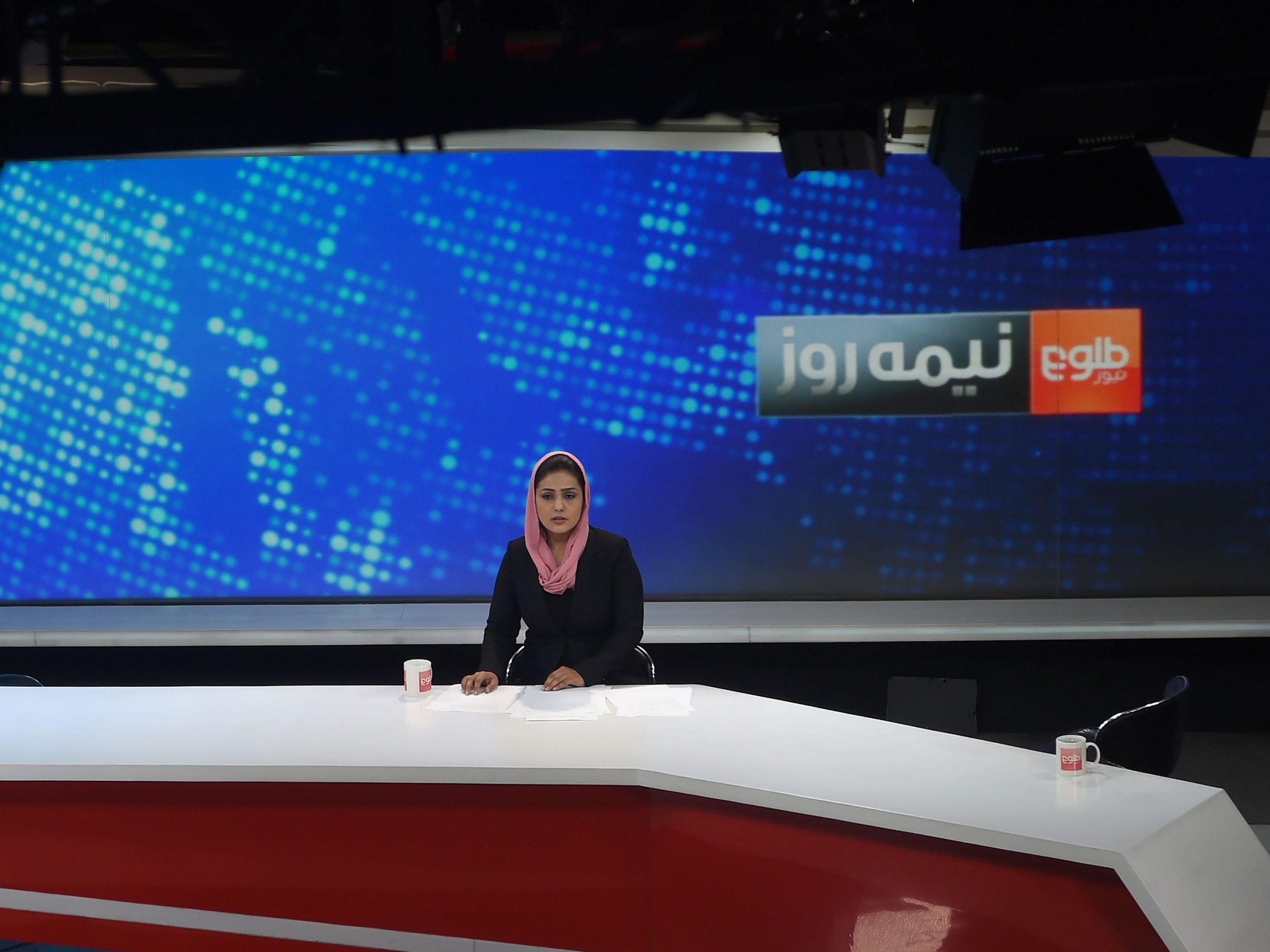 Afghan presenter Zarmina Mohammadi for Tolo News takes part in a live broadcast at Tolo TV station in Kabul in 2018.