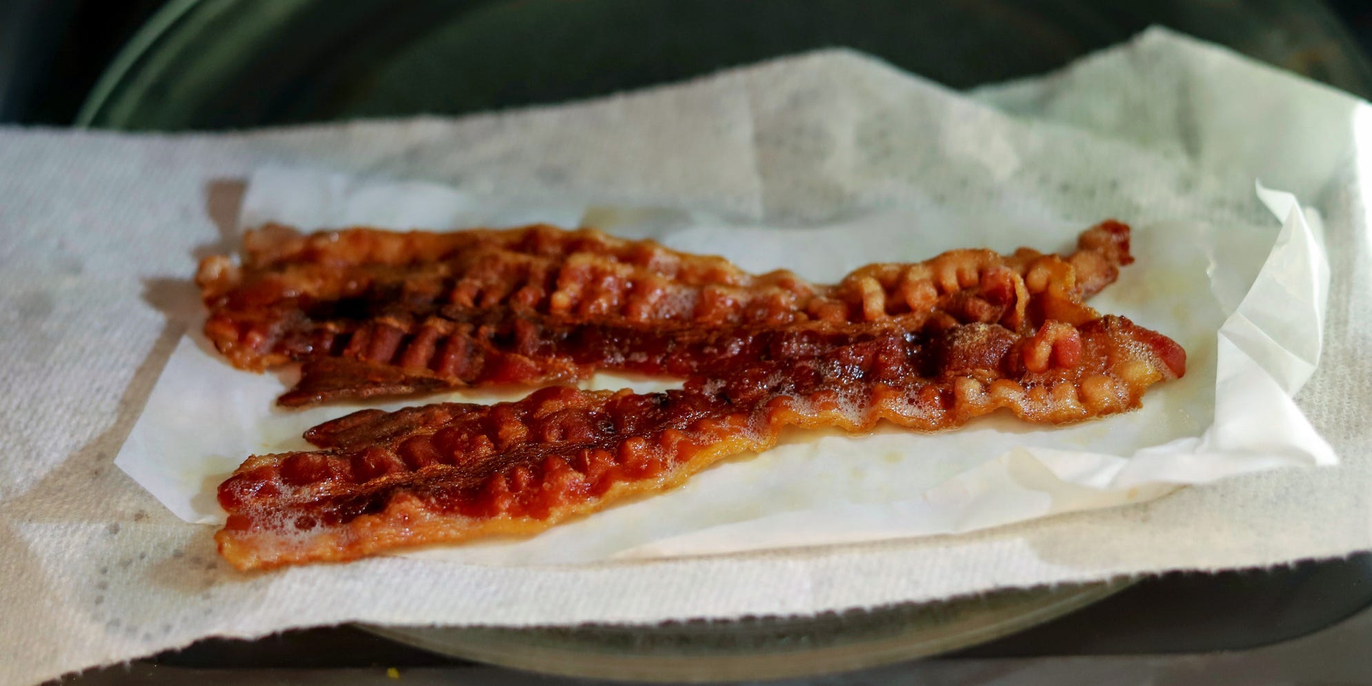 Pieces of bacon on a paper towel.