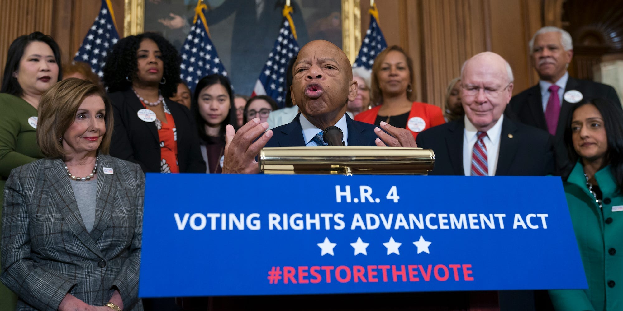 Civil rights leader Rep. John Lewis, D-Ga., flanked by Speaker of the House Nancy Pelosi, D-Calif., left, and Sen. Patrick Leahy, D-Vt., speaks at an event with House Democrats before passing the Voting Rights Advancement Act to eliminate potential state and local voter suppression laws, at the Capitol in Washington, Friday, Dec. 6, 2019.