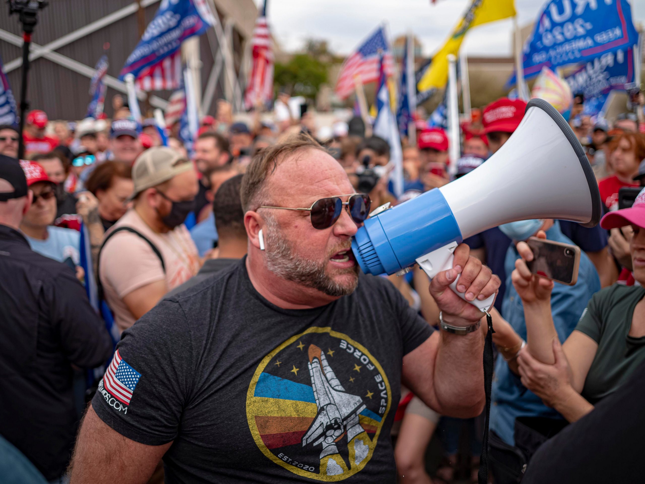 US far-right radio show host Alex Jones (C) speaks to supporters of US President Donald Trump as they protest in front of the Maricopa County Election Department while votes are being counted in Phoenix, Arizona, on November 6, 2020.