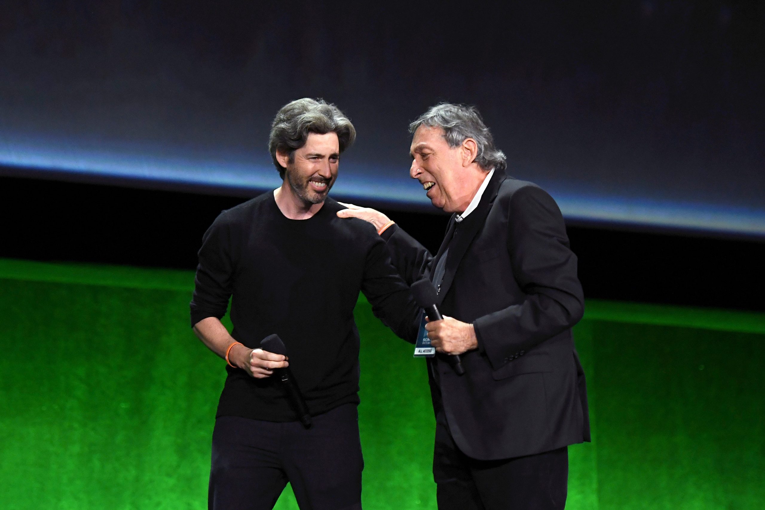 Jason Reitman and Ivan Reitman laughing on stage