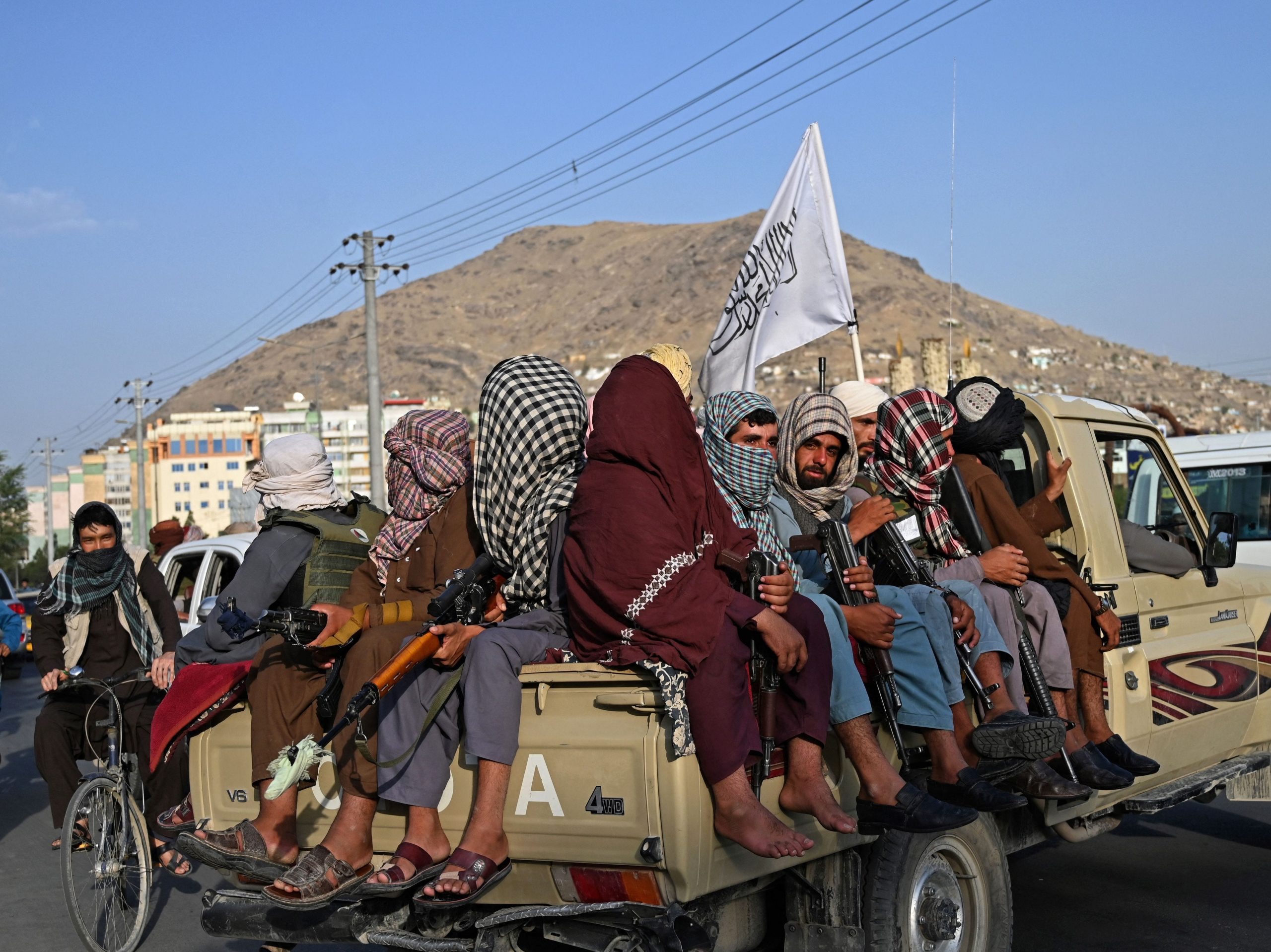 Taliban fighters in a vehicle patrol the streets of Kabul on August 23, 2021, with their armed forces patrolling the streets and manning checkpoints.