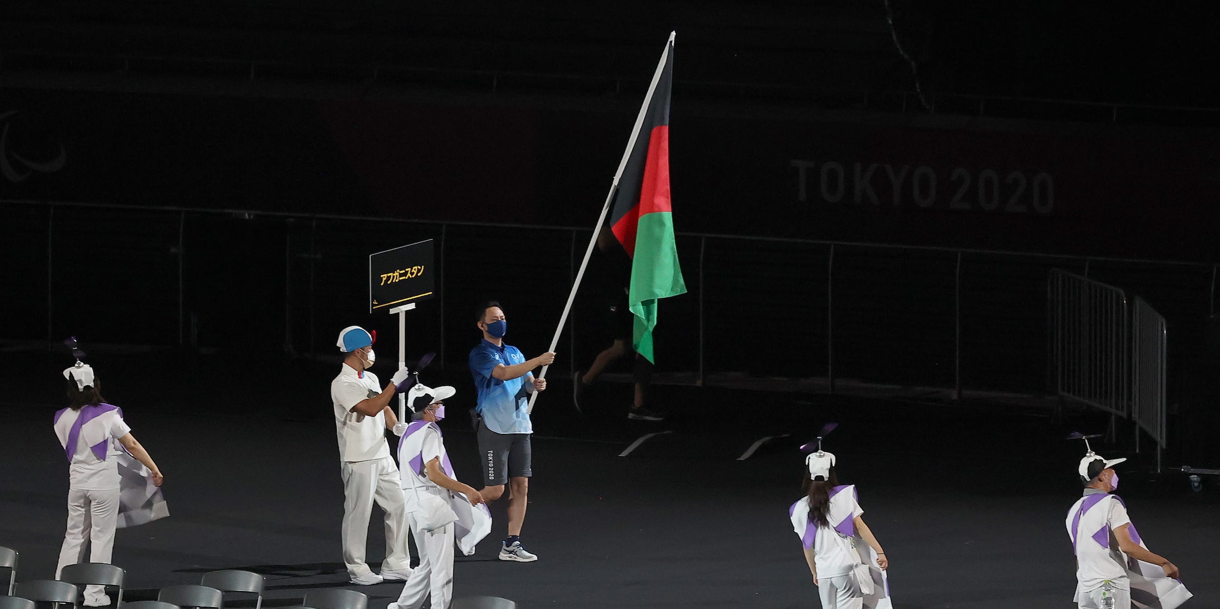 A volunteer holds the flag of Afghanistan in the parade of athletes during the opening ceremony of the Tokyo 2020 Paralympic Games at the Olympic Stadium on August 24, 2021 in Tokyo, Japan.