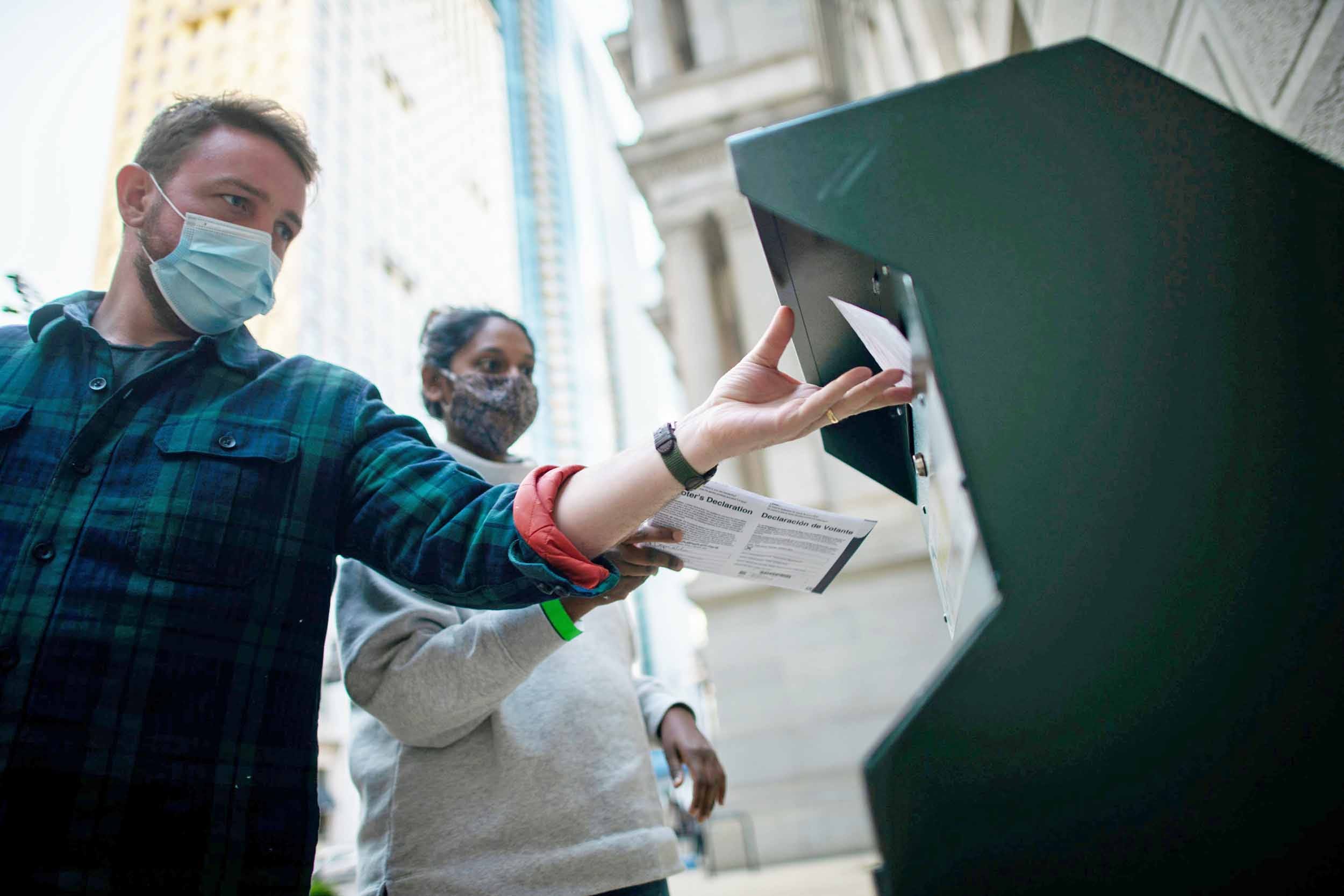 Voters cast their early voting ballot at drop box outside of City Hall on October 17, 2020 in Philadelphia, Pennsylvania.