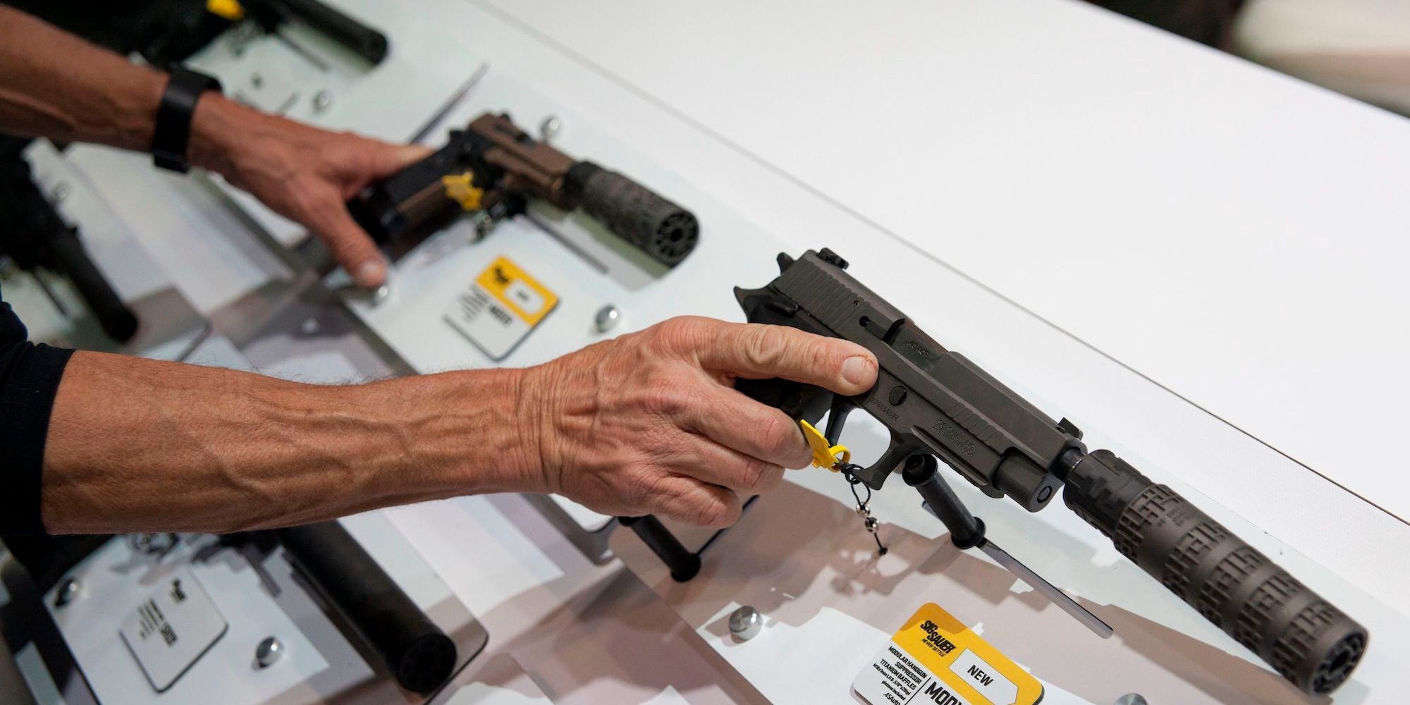 hand holding guns on display