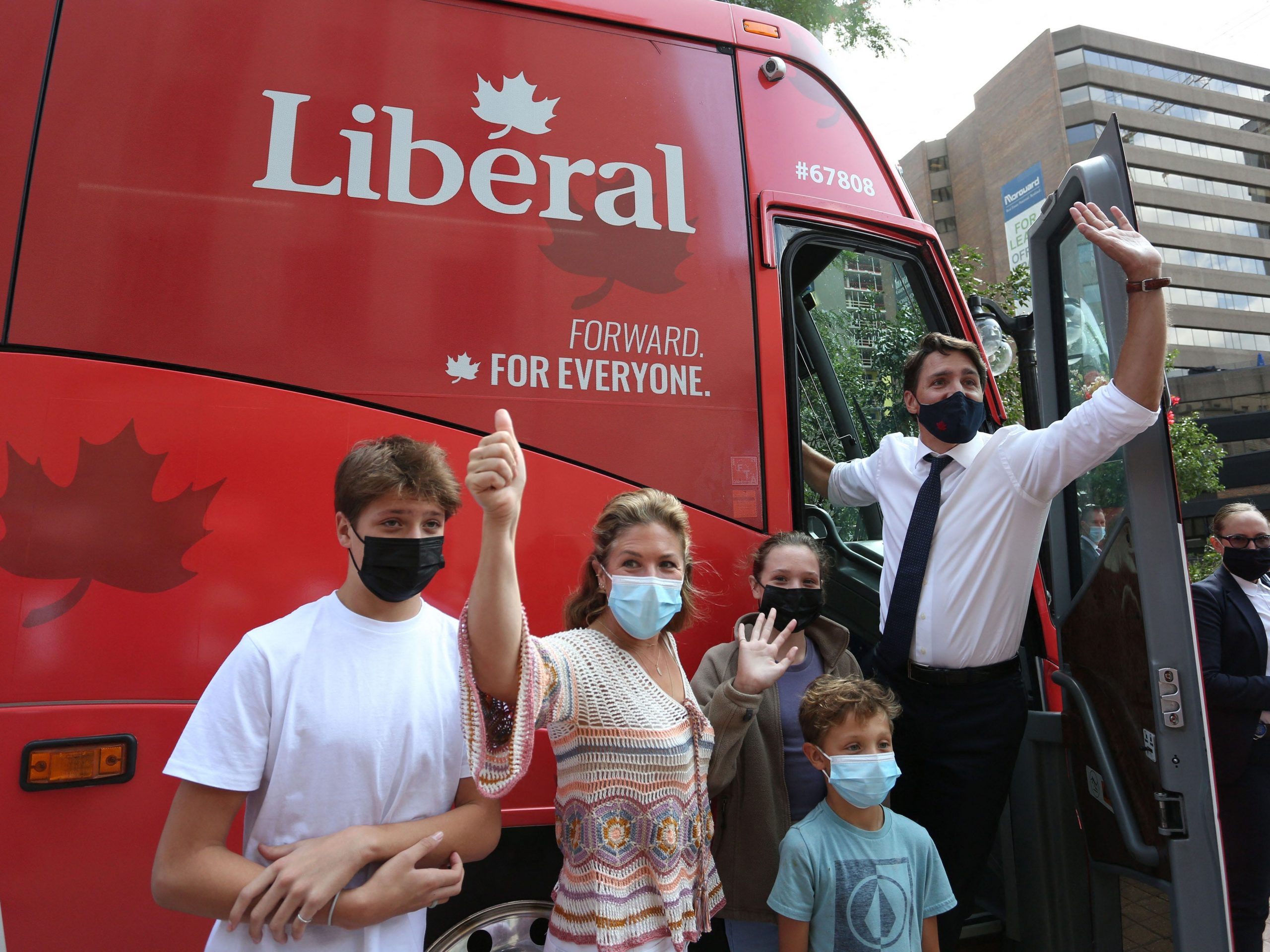 Canada's Prime Minister Justin Trudeau (R), his wife Sophie Gregoire Trudeau and their children Xavier (L-R), Ella-Grace and Hadrien waves to supporters while boarding his campaign bus on August 15, 2021 in Ottawa, Canada.