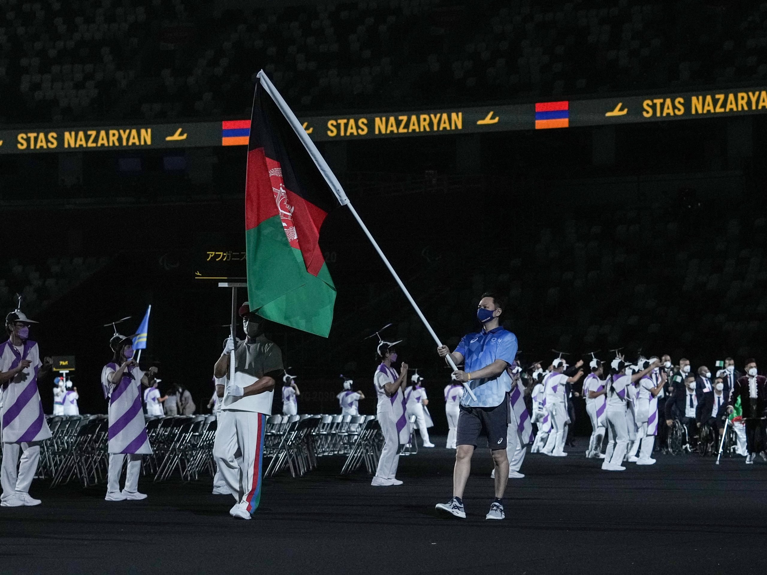 The flag of Afghanistan is carried out at the opening ceremony for the Tokyo 2020 Paralympic Games