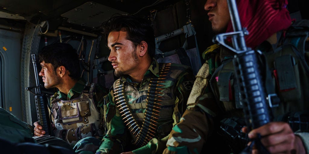 Soldiers prepare for landing on board a UH-60 during a resupply flight for an outpost in the Shah Wali Kot district north of Kandahar, Afghanistan, Thursday, May 6, 2021