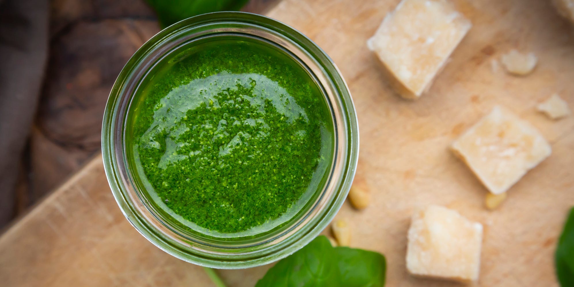 Overhead shot of some basil pesto in a jar.