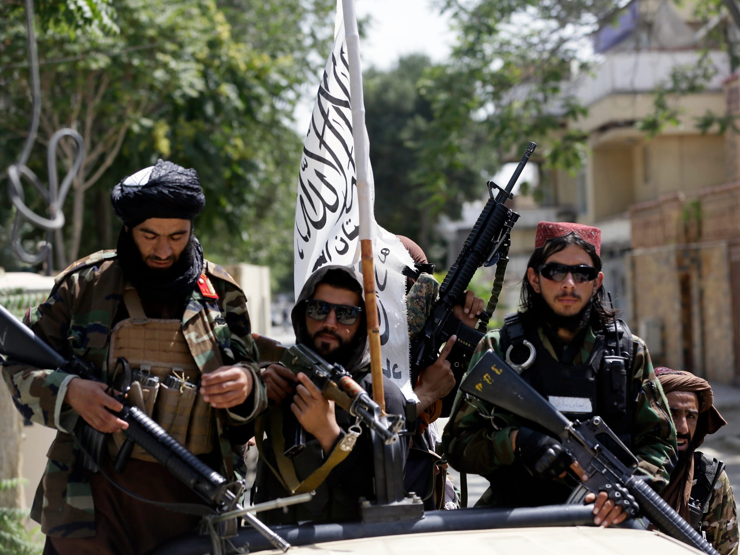 Taliban fighters display their flag on patrol in Kabul, Afghanistan, Thursday, Aug. 19, 2021.