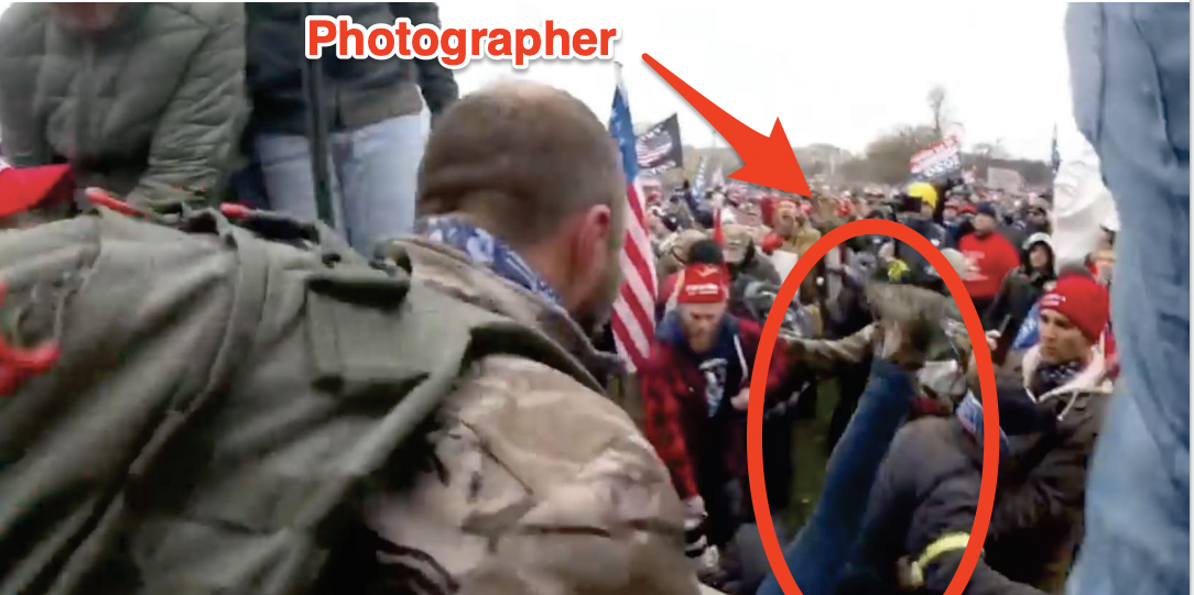 The photographer is seen here being pushed over the stone wall during the Jan. 6 riot.