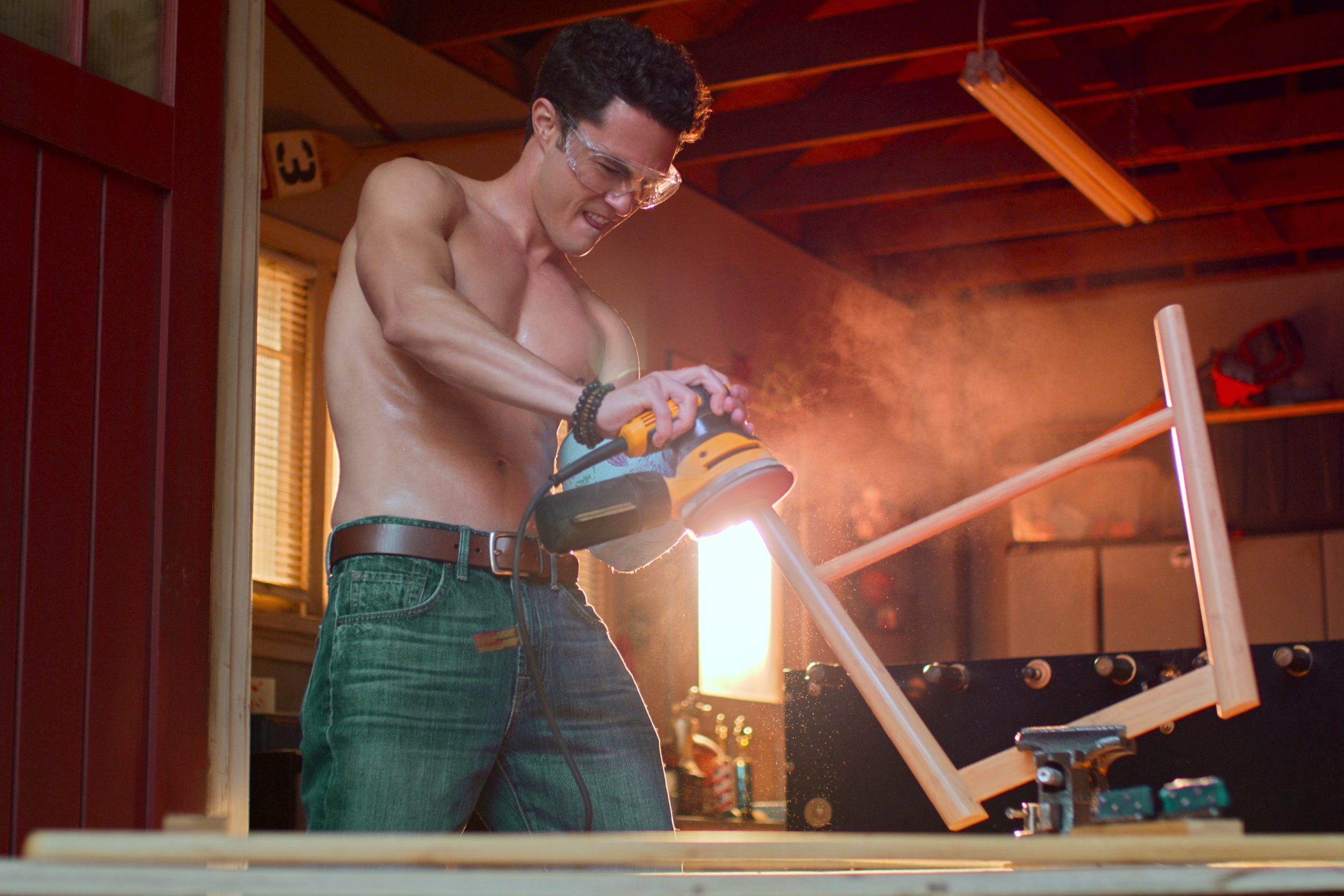 Darren Barnet as Paxton Hall-Yoshida fixing a table leg on season two of "Never Have I Ever."
