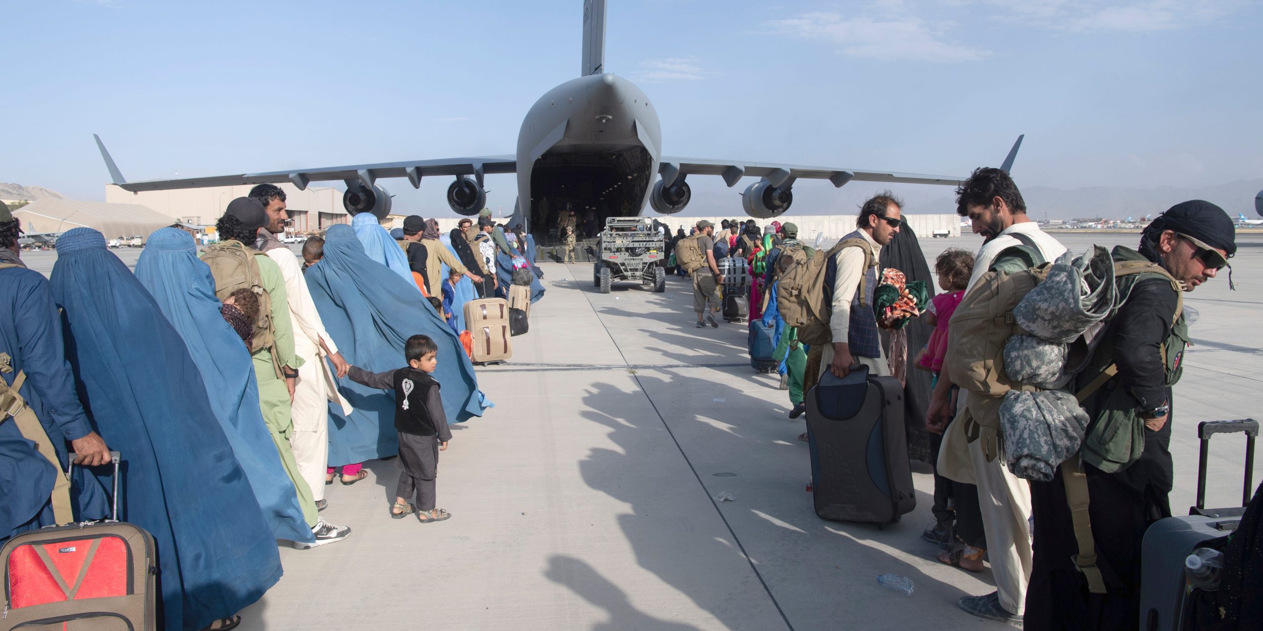 In this image provided by the U.S. Air Force, U.S. Air Force loadmasters and pilots assigned to the 816th Expeditionary Airlift Squadron, load people being evacuated from Afghanistan onto a U.S. Air Force C-17 Globemaster III at Hamid Karzai International Airport in Kabul, Afghanistan, Tuesday, Aug. 24, 2021.