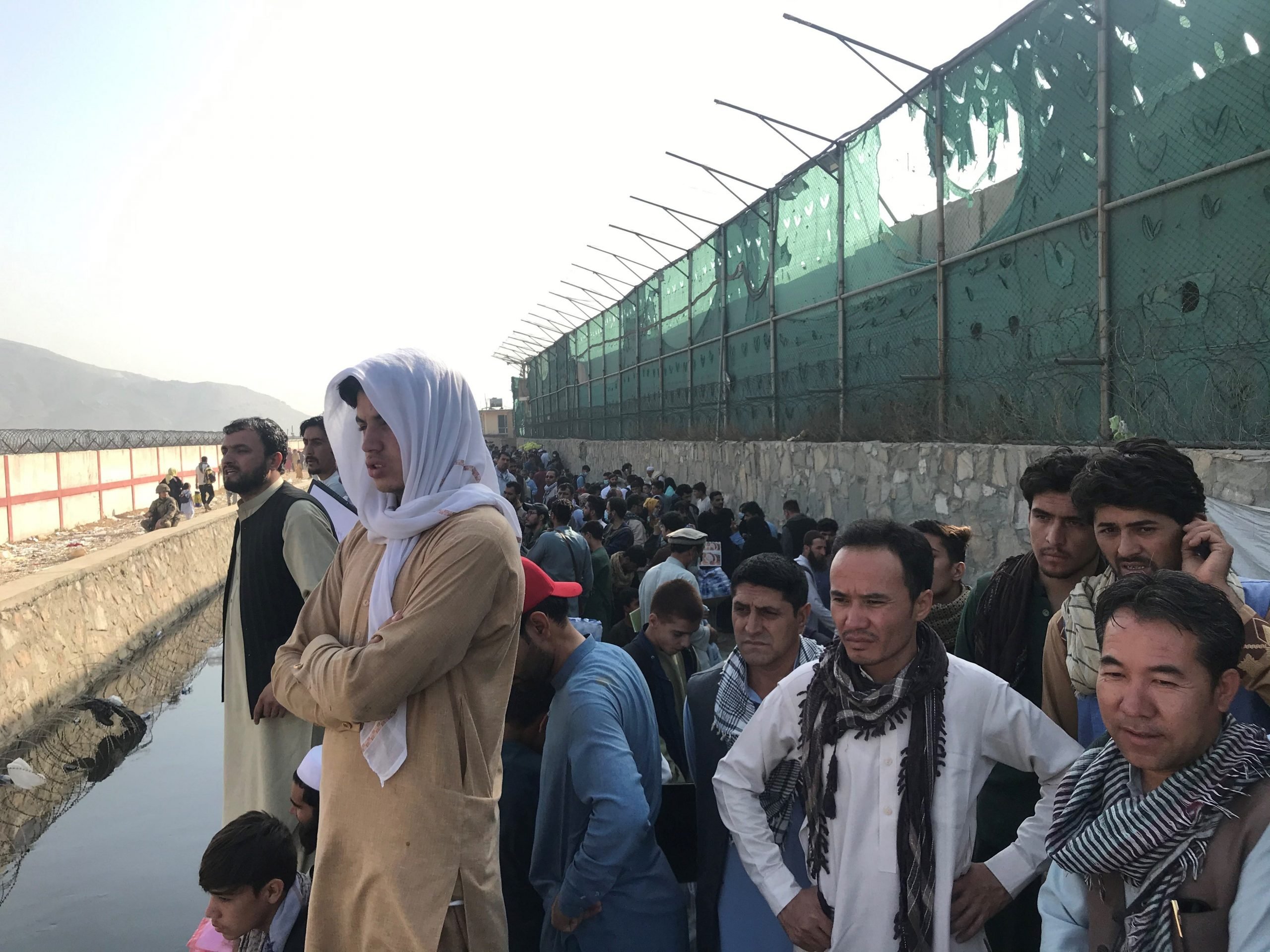 Afghans gather near a gate of Kabul airport