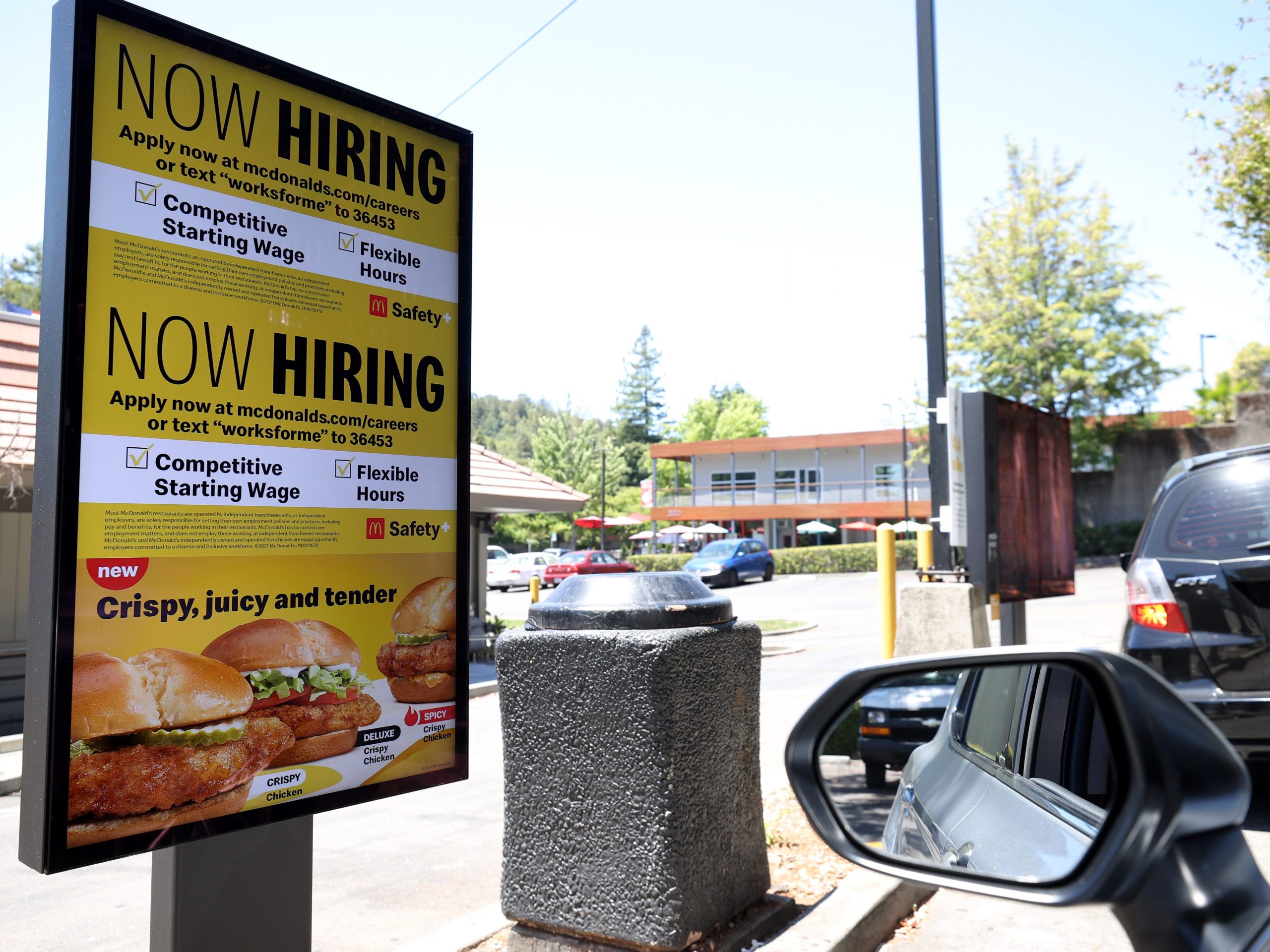 A "Now Hiring" sign is posted in the drive thru of a McDonald's restaurant on July 07, 2021 in San Rafael, California.