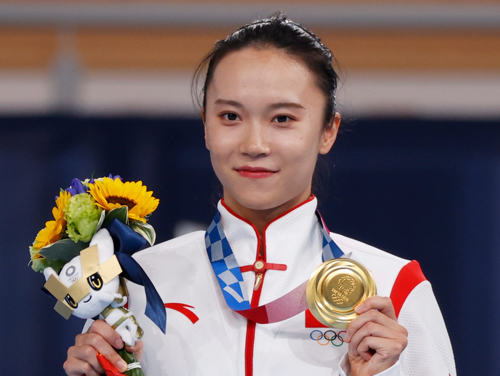 Gold medalist Zhu Xueying of China celebrates on podium after the Women's Trampoline Final