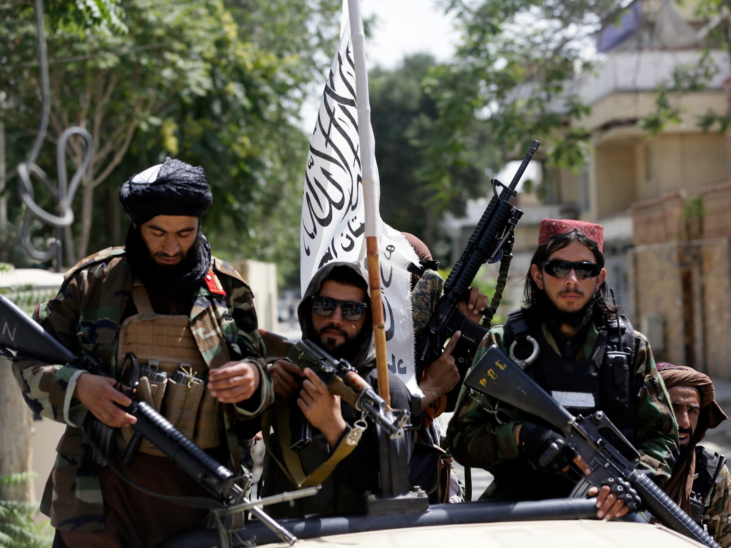 Taliban fighters display their flag on patrol in Kabul, Afghanistan, Thursday, Aug. 19, 2021.