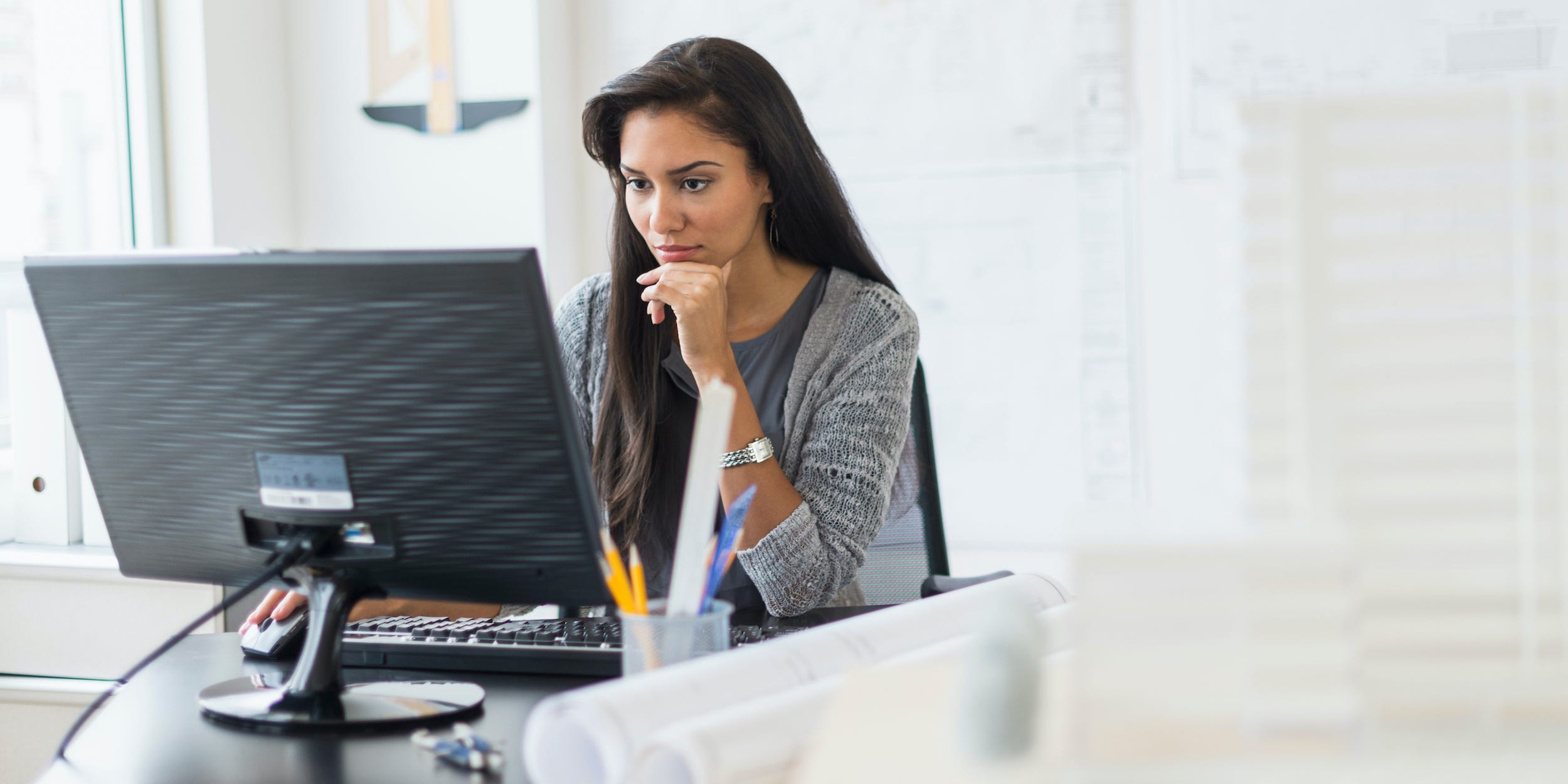 business professional using desktop PC at office