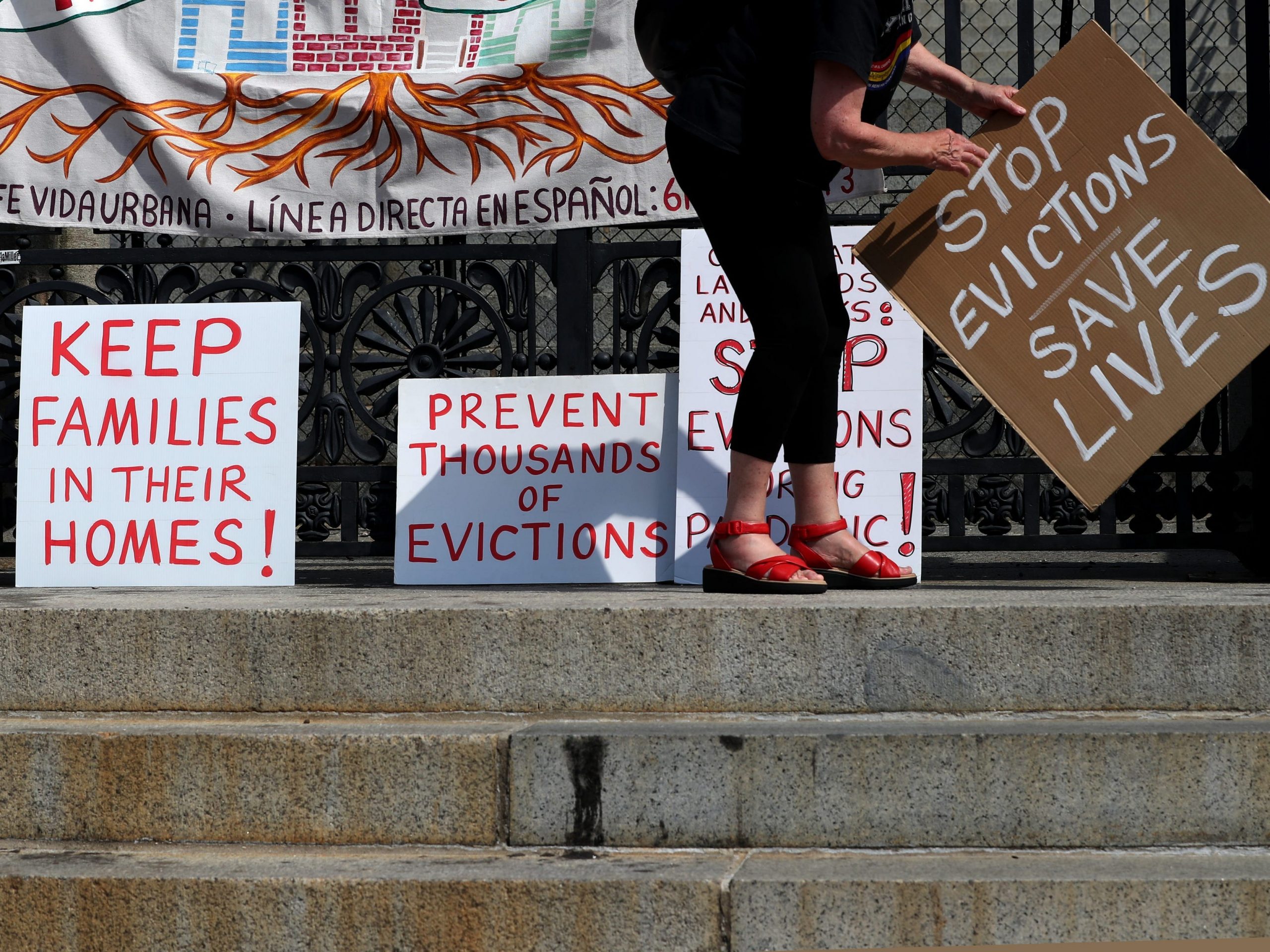 Signs for no evictions on the State House wall.