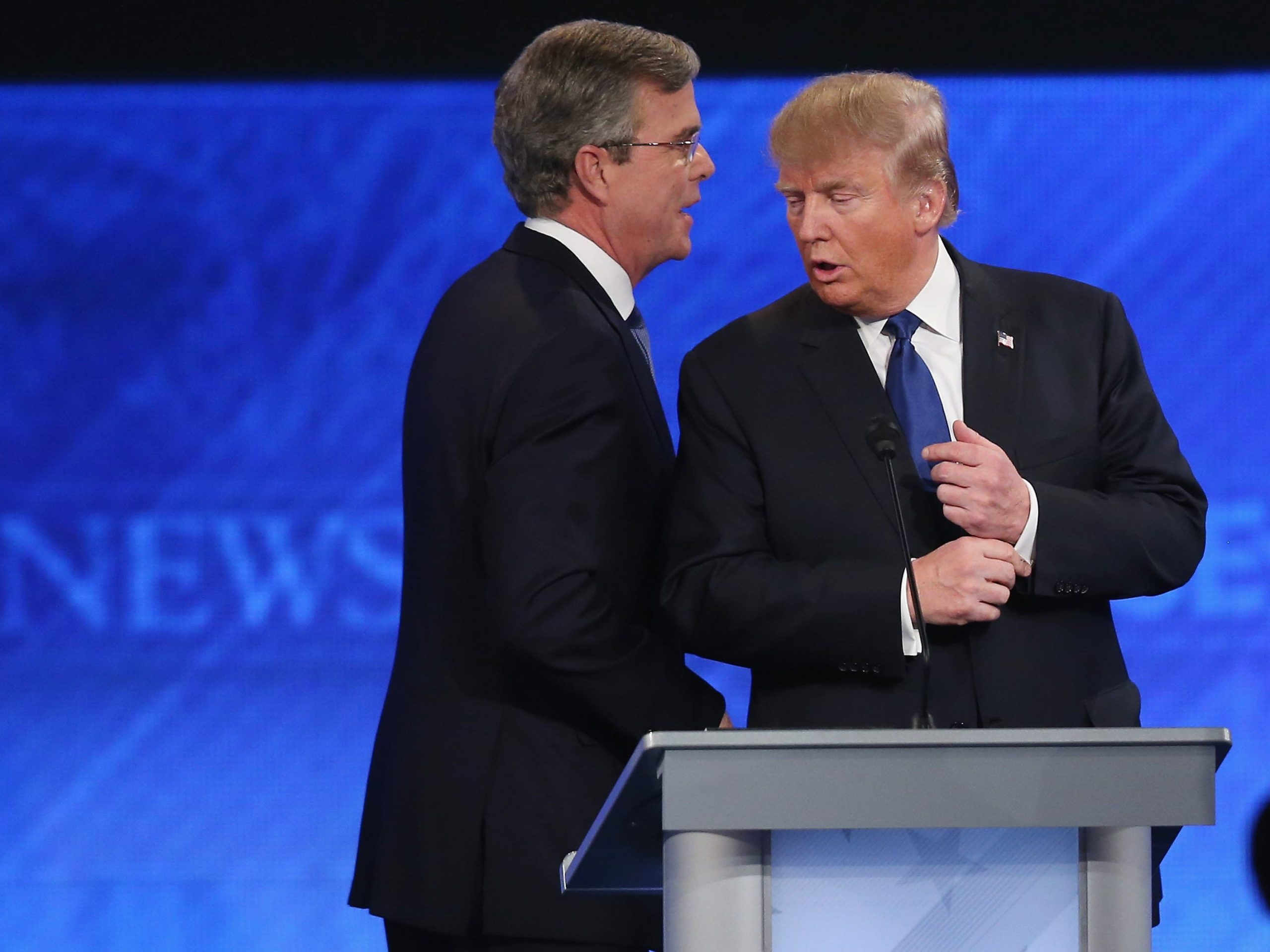 Presidential candidates Jeb Bush and Donald Trump talk following a Republican presidential debate in Manchester, New Hampshire on February 6, 2016.