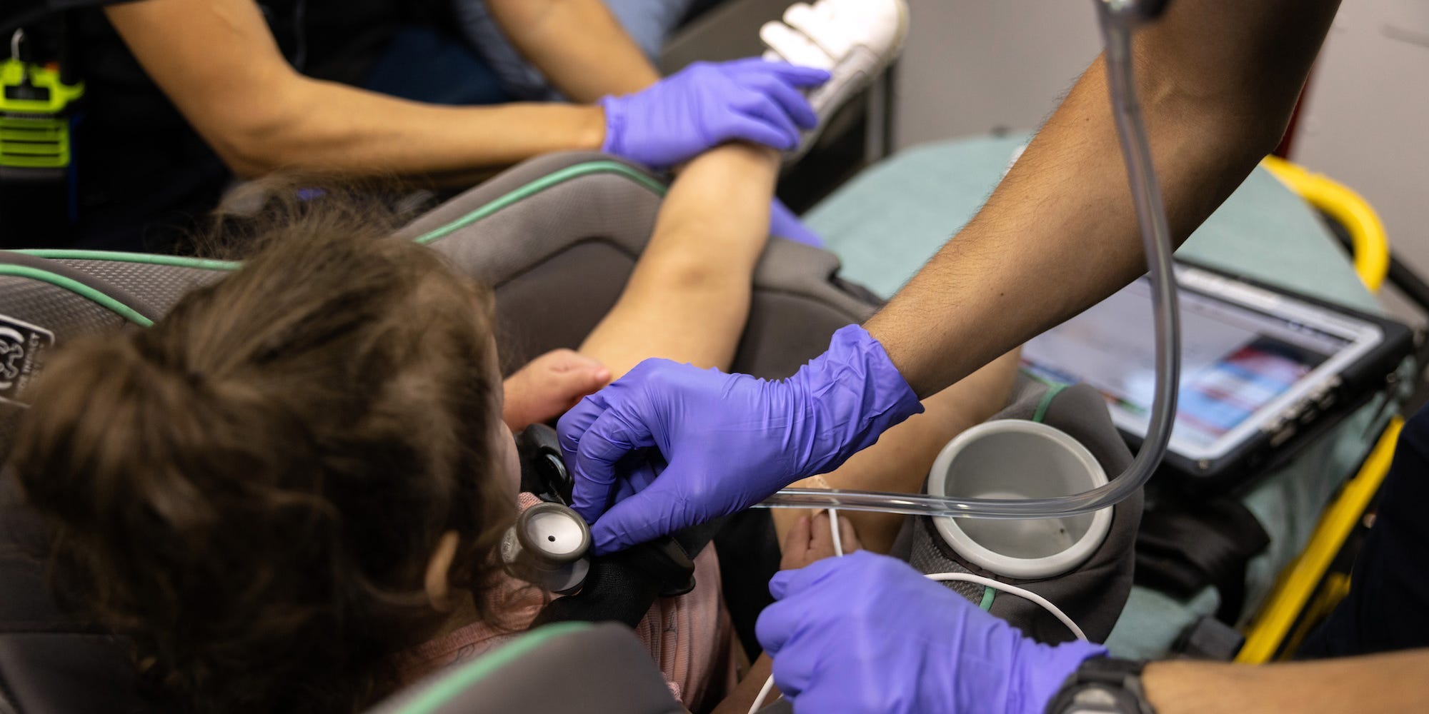 EMS medics from the Houston Fire Department check the breathing of a girl, age 2, with COVID-19 before transporting her to a hospital on August 25, 2021 in Houston, Texas.