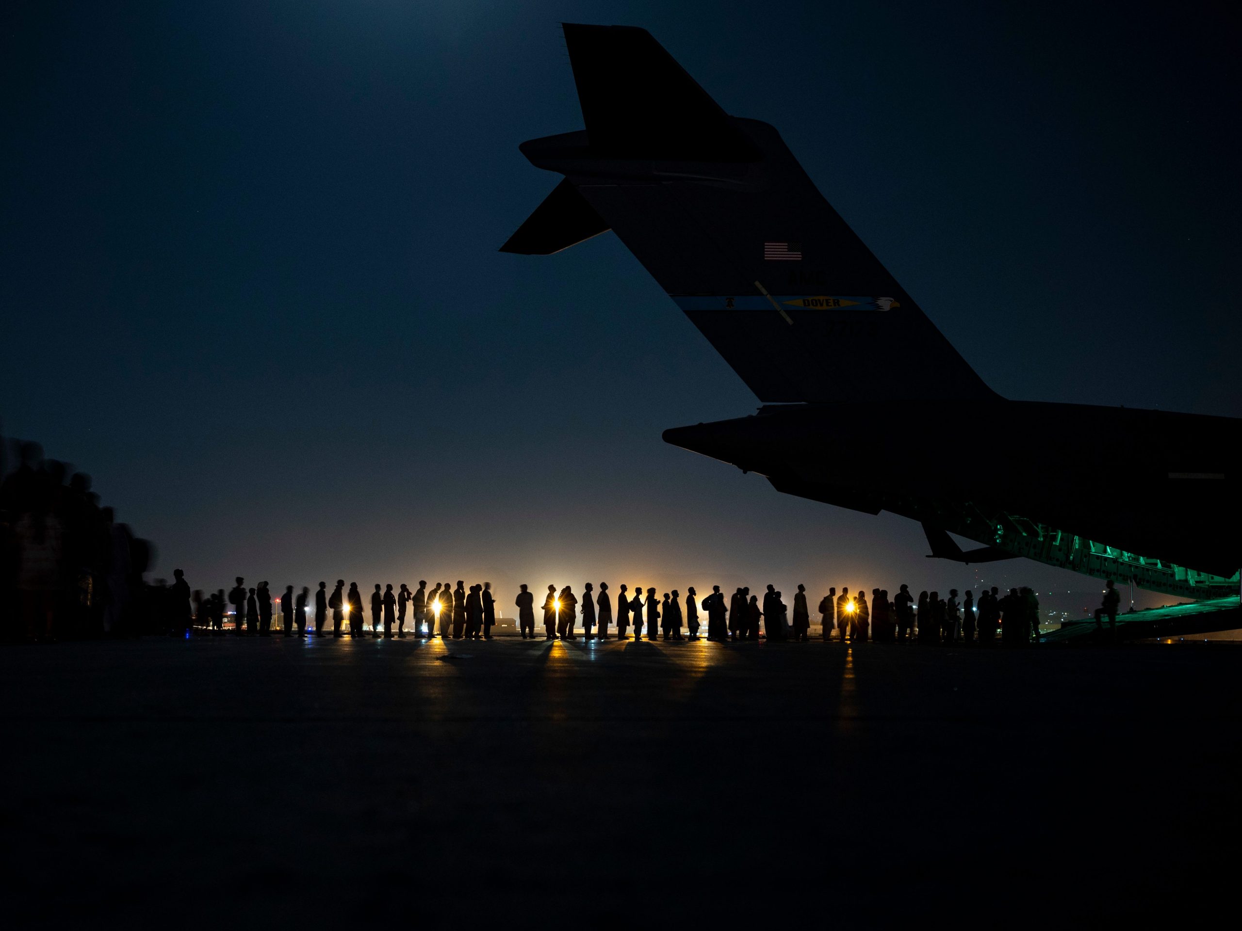 Air crew prepares to load evacuees aboard a C-17 Globemaster III aircraft in support of the Afghanistan evacuation at Hamid Karzai International Airport on August 21, 2021 in Kabul, Afghanistan.