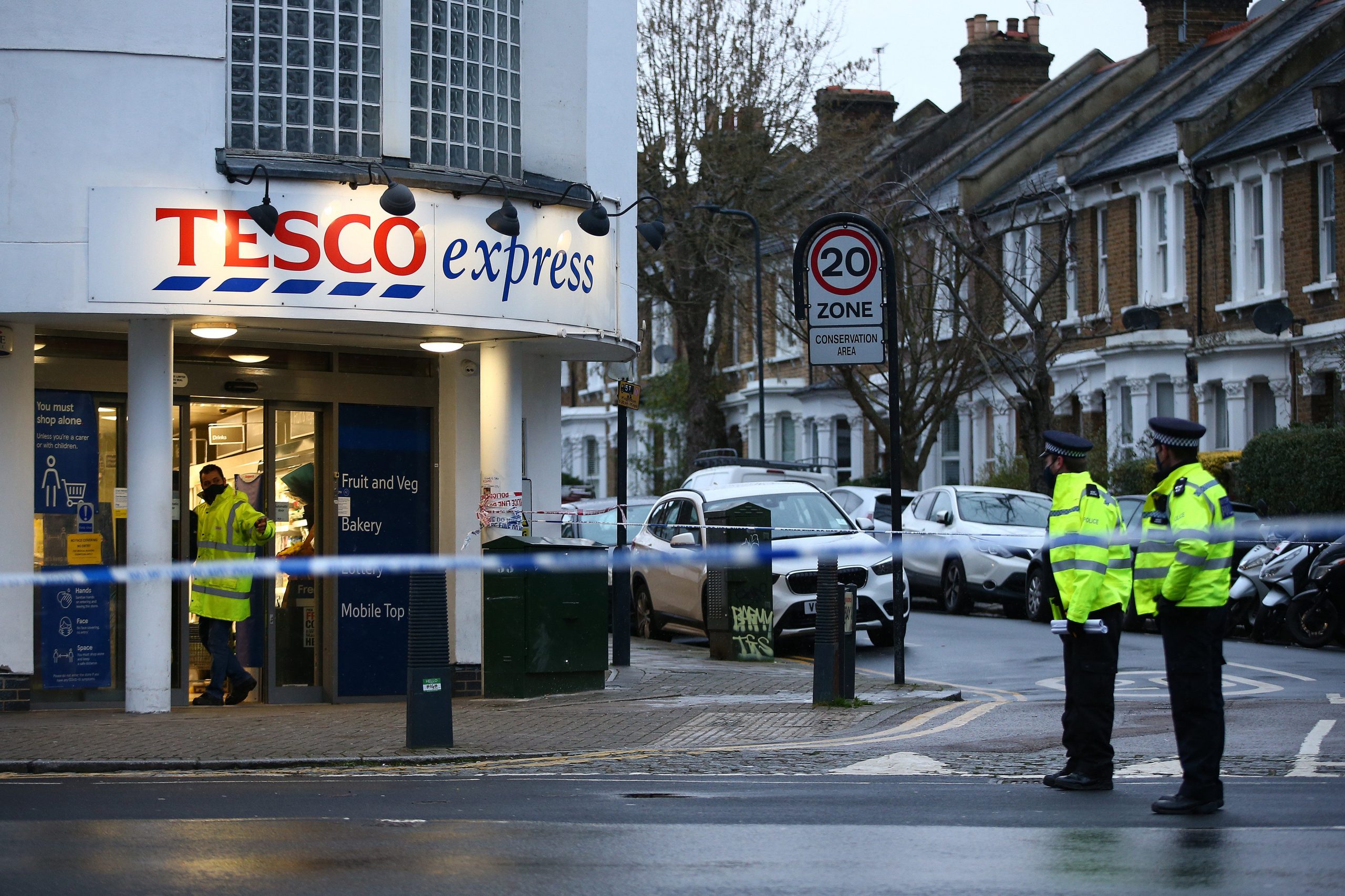 Metropolitan Police officer stand outside a Tesco inside a police cordon on February 7, 2021 in London, England.