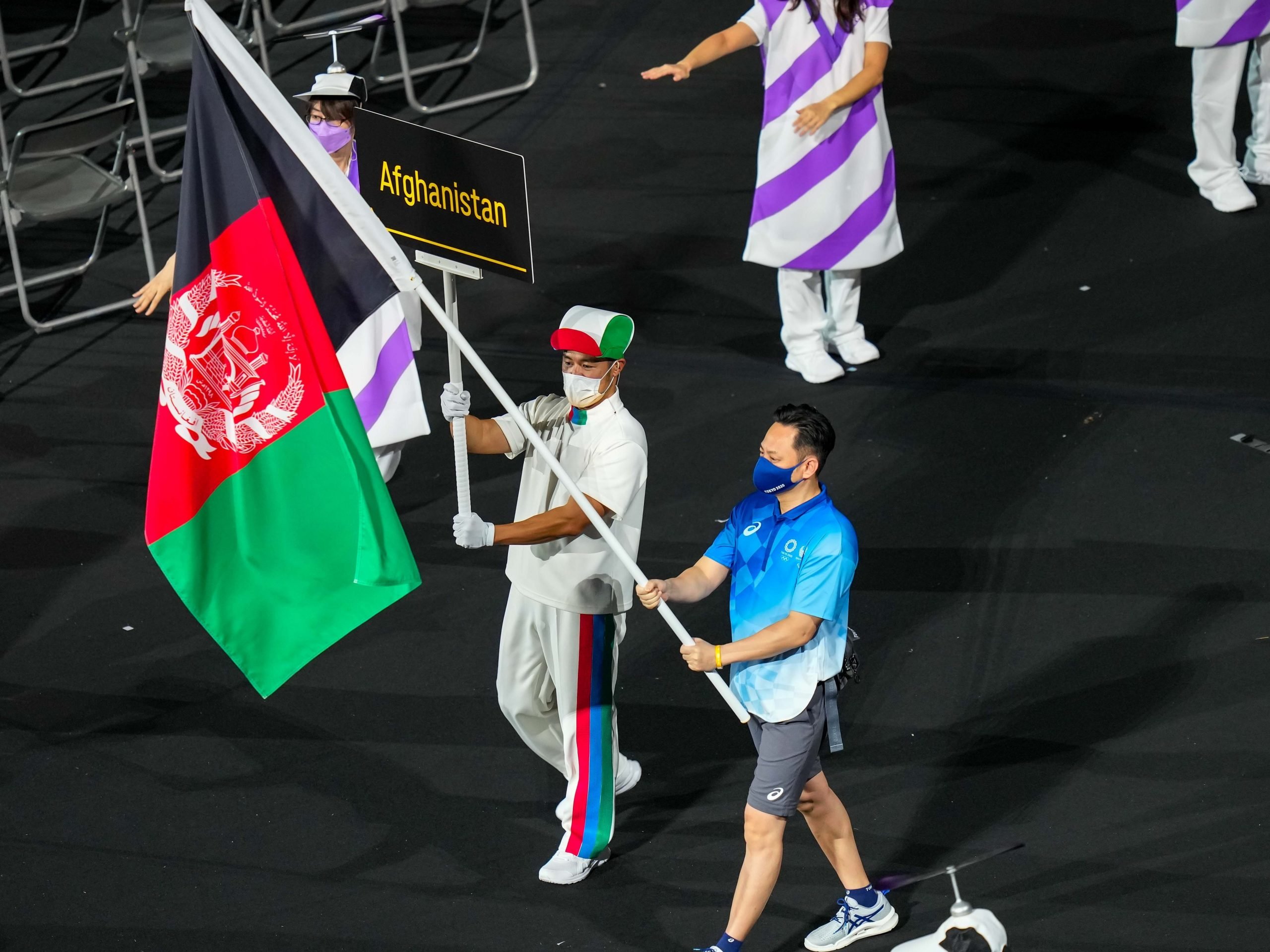 A flag bearer carries the Afghanistan flag into the stadium during the opening ceremony for the 2020 Paralympics at the National Stadium in Tokyo, Tuesday, Aug. 24, 2021.