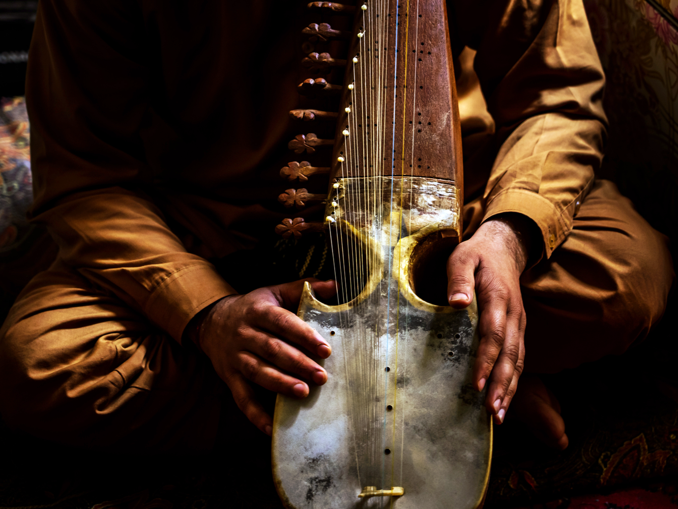 A stock image of a man playing the rubab