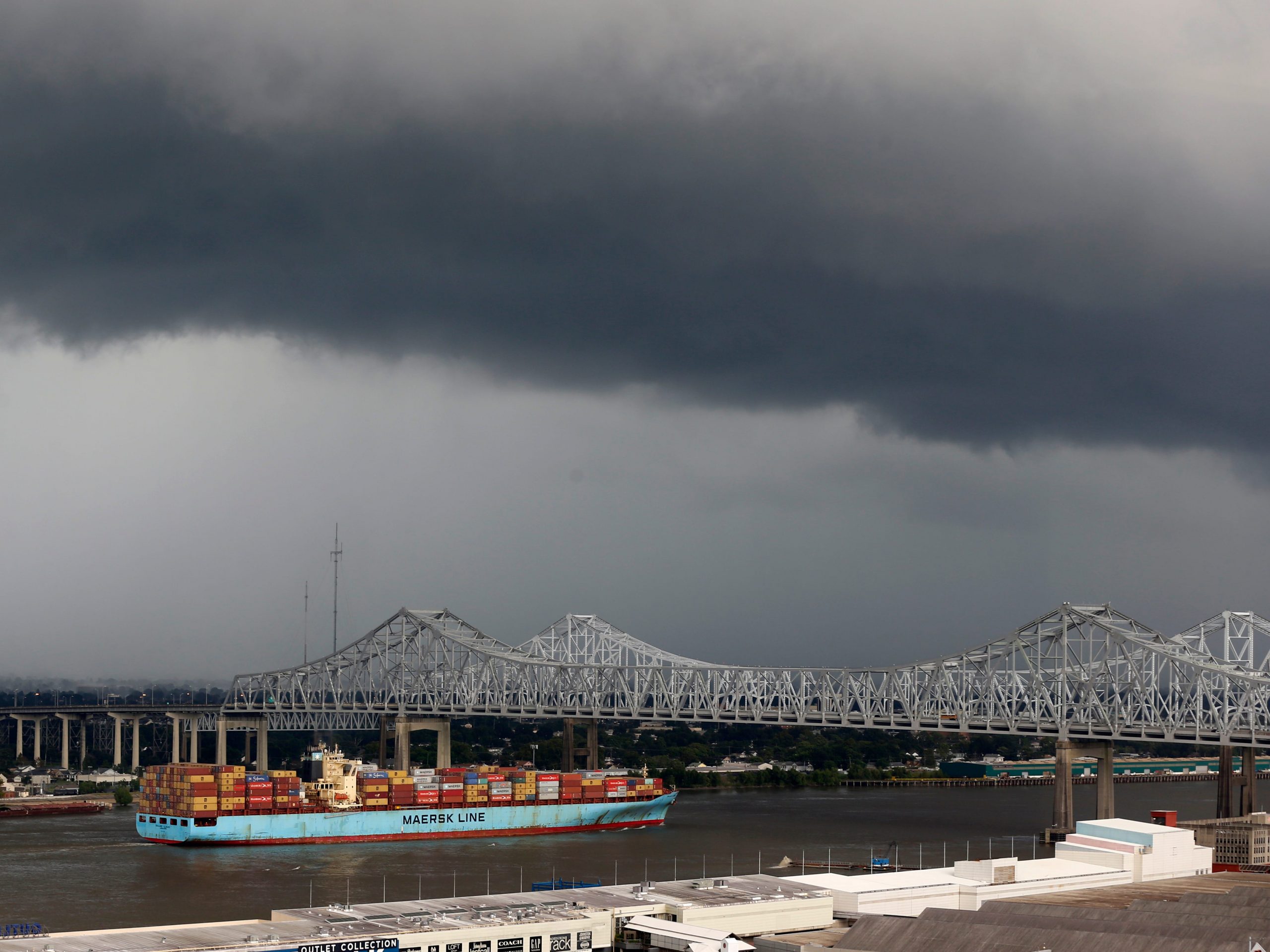 The "Sealand Illinois," a Hong Kong registered cargo ship, passes under the Crescent City Connection Bridge on the Mississippi River in New Orleans, Tuesday, Aug. 13, 2019.