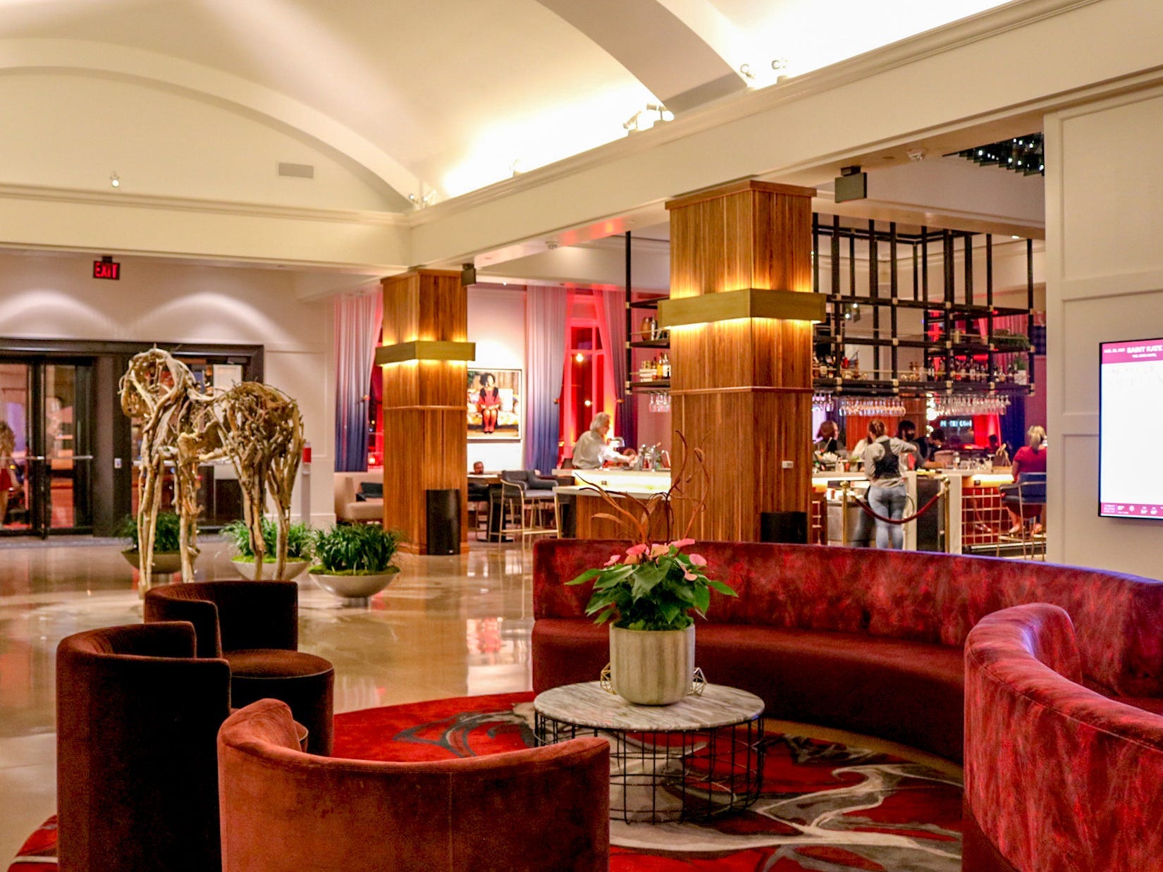 The classy interior of Saint Kate - The Arts Hotel, with red seats and arches