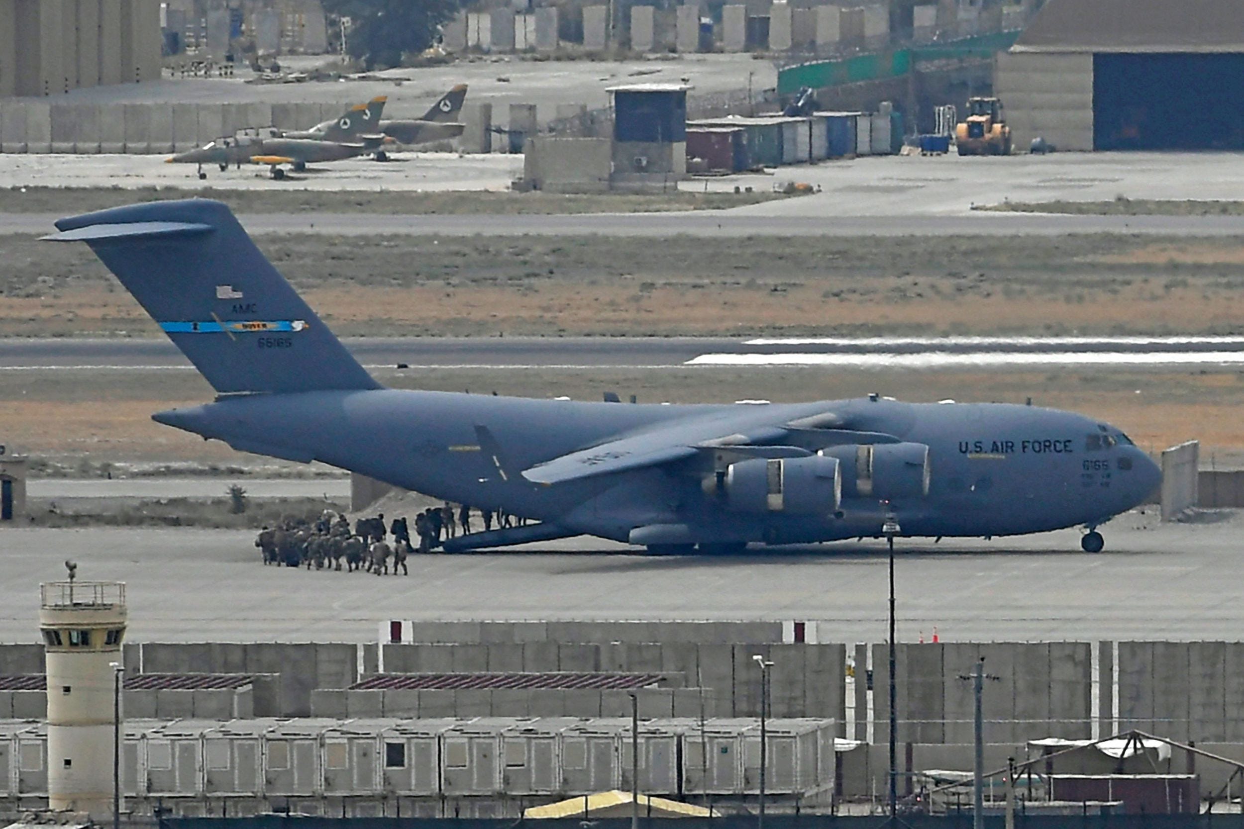 people board a us air force plane in kabul