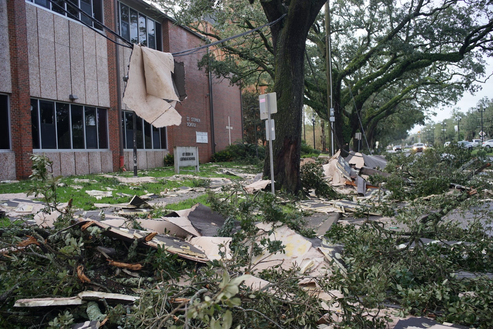 Debris is seen lying next to a schoolhouse.
