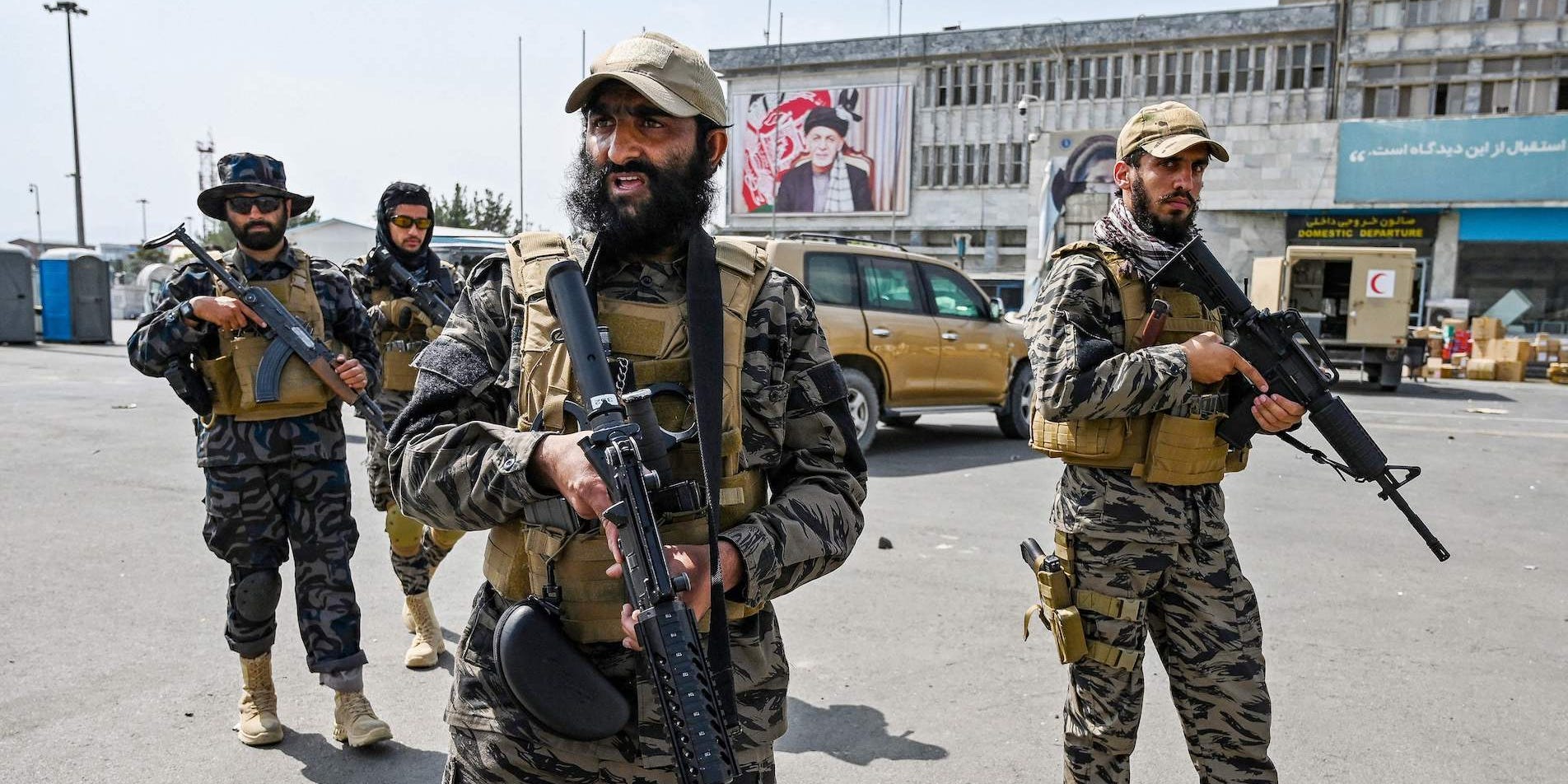 Taliban fighters with guns outside Kabul airport