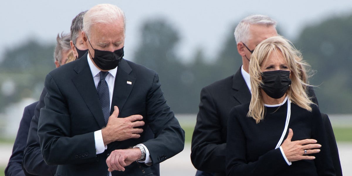 US President Joe Biden looks down alongside First Lady Jill Biden as they attend the dignified transfer of the remains of a fallen service member at Dover Air Force Base in Dover, Delaware, August, 29, 2021, one of the 13 members of the US military killed in Afghanistan last week.