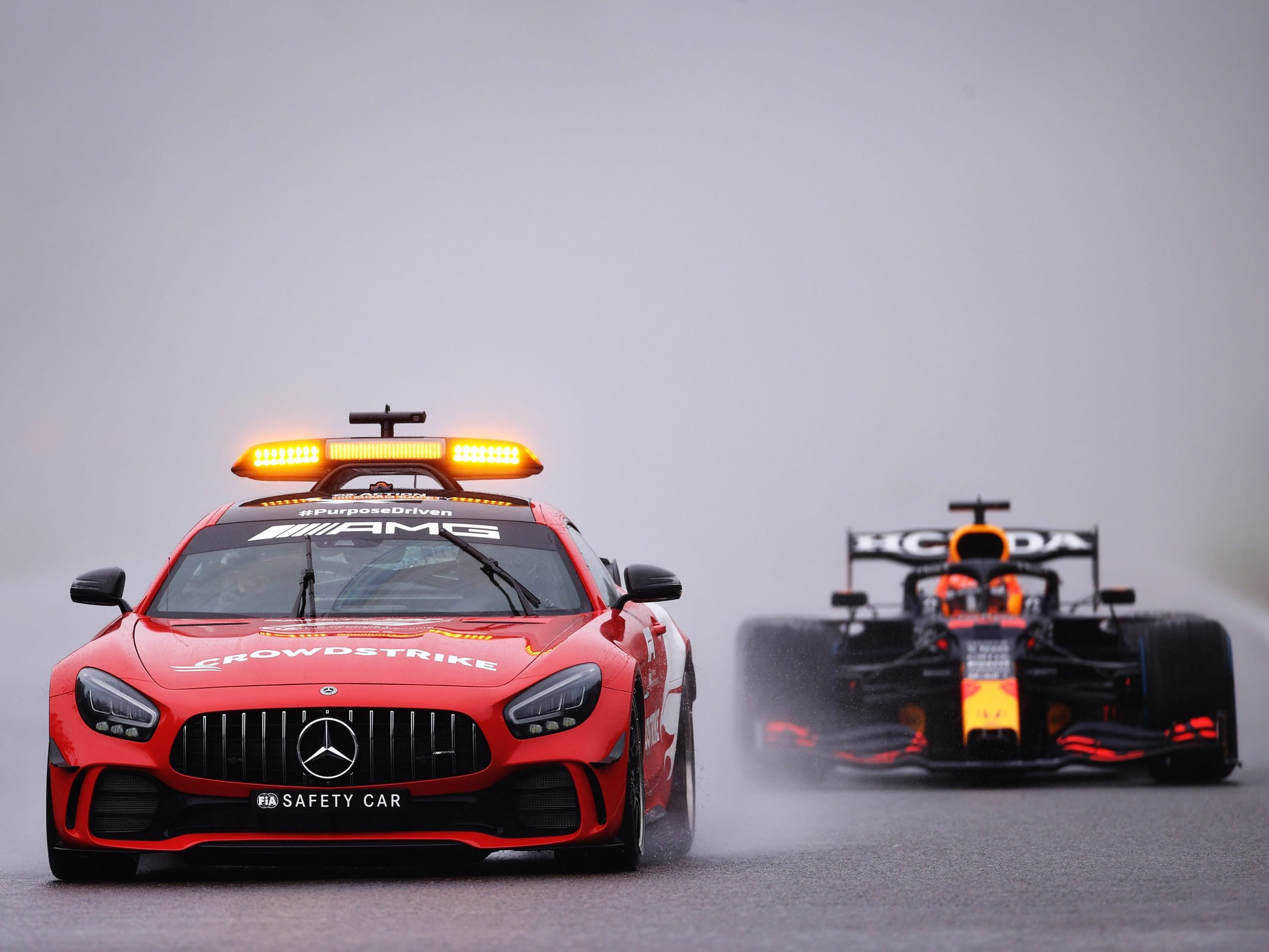 Max Verstappen drives behind the safety car during a wet Belgian Grand Prix