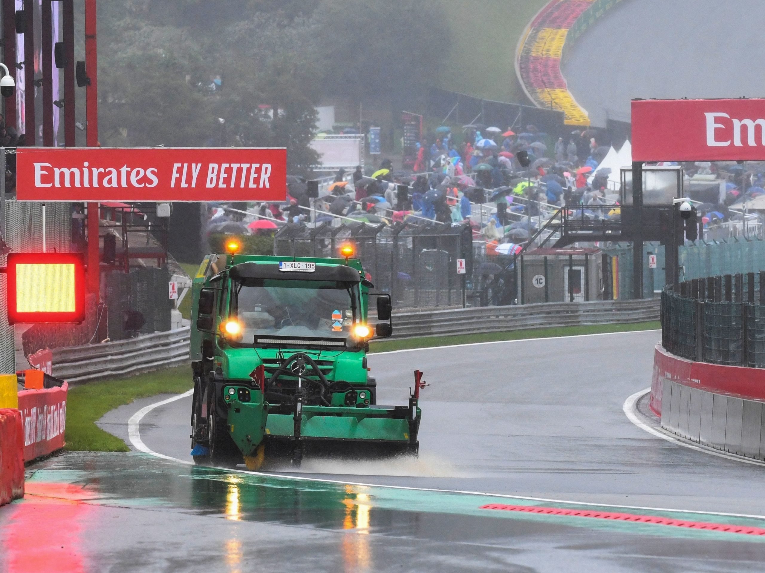 A technical vehicle clears water from the track as the race is suspended over rainy weather during the Formula One Belgian Grand Prix at the Spa-Francorchamps circuit